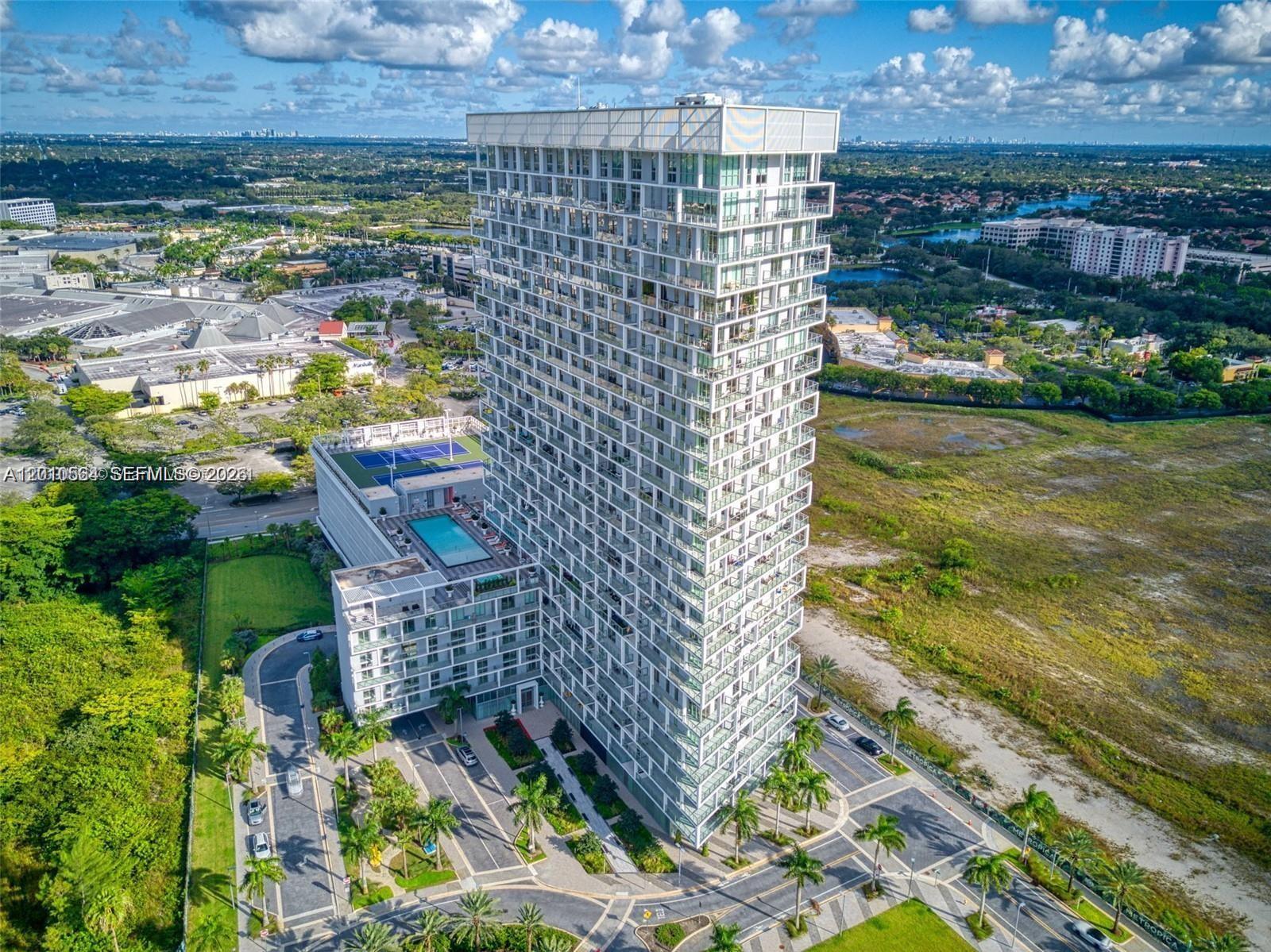 *Corner Residence* Featuring porcelain tiles throughout, high impact floor to ceiling windows, lots of natural light and incredible views of the Everglades. Located on the SW corner of this elegant building with 40,000 square feet of amenities, including a state-of-the-art fitness center, a rooftop pool deck, private sauna and spa, theater room, game room, kid's play room, two tennis courts, outdoor kitchen and barbeque area, concierge service and more. Very large wraparound balcony where you can enjoy beautiful sunsets. This building is close to top entertainment, shopping and business areas. Two pets are allowed with a total combined weight of 75 pounds OR one pet up to 50 pounds. Total size is 1,399 square feet (1087 + 313 of balcony ).