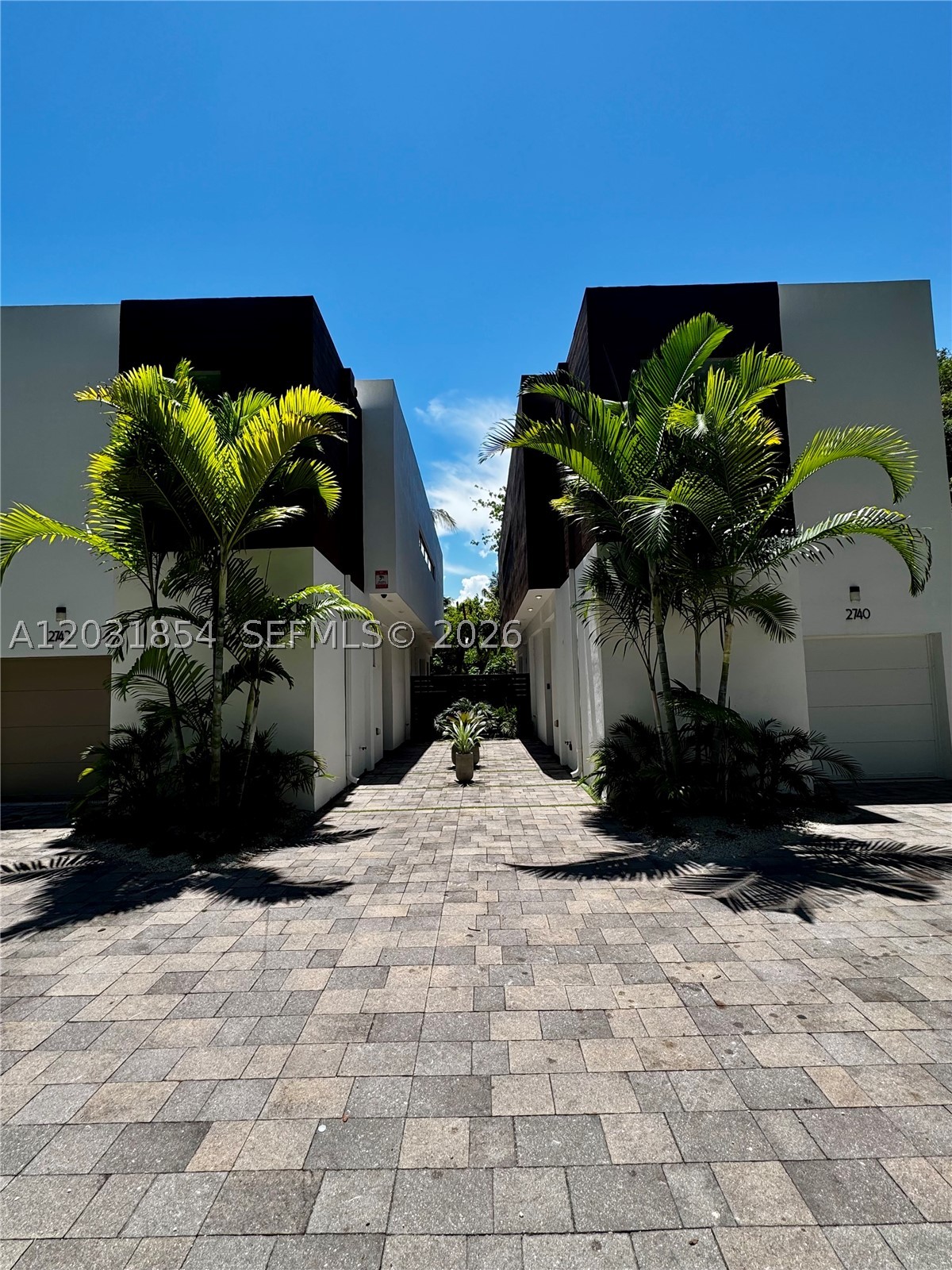 Modern Duplex located just steps away from Grove Central! Short walking distance to Coconut Grove. The detached duplex is located on a quiet tree lined street! The gated and completely fenced property offers a welcoming and spacious back patio for small gatherings. Perfect for a playground. Impact doors and windows, tiles throughout. The kitchen is equipped with stainless steel appliances and custom cabinets. Each of the three generously sized bedroom has it's en-suite bathroom. Powder room on the first floor for the convenience of you guests. 1 car garage, plus space to park 2 vehicles outside.Great school district, the duplex is conveniently located close to Brickell, Coral Gables and South Miami.