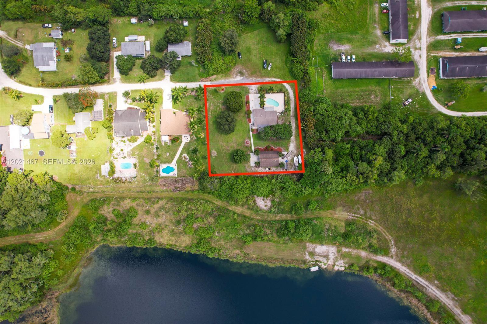 GREAT OPPORTUNITY TO LIVE IN A PEACEFUL. SINGLE FAMILY POOL HOME ON .96 ACRES . Water Heater, Water Filtratioon System, Impact Windows. No HOA Community. INCLUDES A SUPERSIZED STORAGE BARN WITH BATHROOM AND KITCHENETTE WHICH HAS ROLL UP DOORS. LARGE ENOUGH FOR RV STORAGE OR CONVERSION INTO A STABLE AND TACK ROOM. PROPERTY IS PRIVATE ON DEAD END ROAD WITH NO NEIGHBORS BEHIND, IN FRONT OR ON THE SIDE. NO FEES OR RULES SO BRING ALL THE TOYS. HORSES ARE PERMITTED AND PROPERTY CONFIGURATION WOULD ACCOMMODATION A HALF ACRE PADDOCK. THE HOME HAS GOOD LAYOU. GUEST ROOM. THIS PROPERTY IS AN EXTREMELY UNIQUE, HARD TO FIND PROPERTY. YOU CAN BUILD YOUR DREAM HOME OR PLANT YOUR OWN GARDEN.