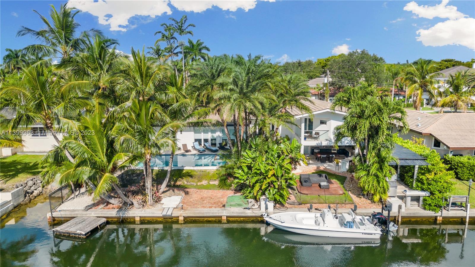 Welcome to paradise! This stunning waterfront home w/Bay access perfectly blends elegance, comfort, & coastal living in the prestigious Gables by The Sea community. The well-designed floor plan features 5 bedrooms, providing ample space for family & guests. An updated kitchen w/modern appliances makes this a culinary enthusiast's dream.  The living areas are thoughtfully designed for relaxation & entertainment.  One of the highlights of this home is its seamless integration of indoor & outdoor living. Discover a private oasis featuring a sparkling heated pool, outdoor kitchen, & a cabana bath. 100' waterfront w/ convenient one-bridge ocean access. Fully permitted brand new 17,000 lb. Neptune boatlift, Impact windows & 2020 roof. Prime location on double cul de sac w/ 24/7 guard gate.