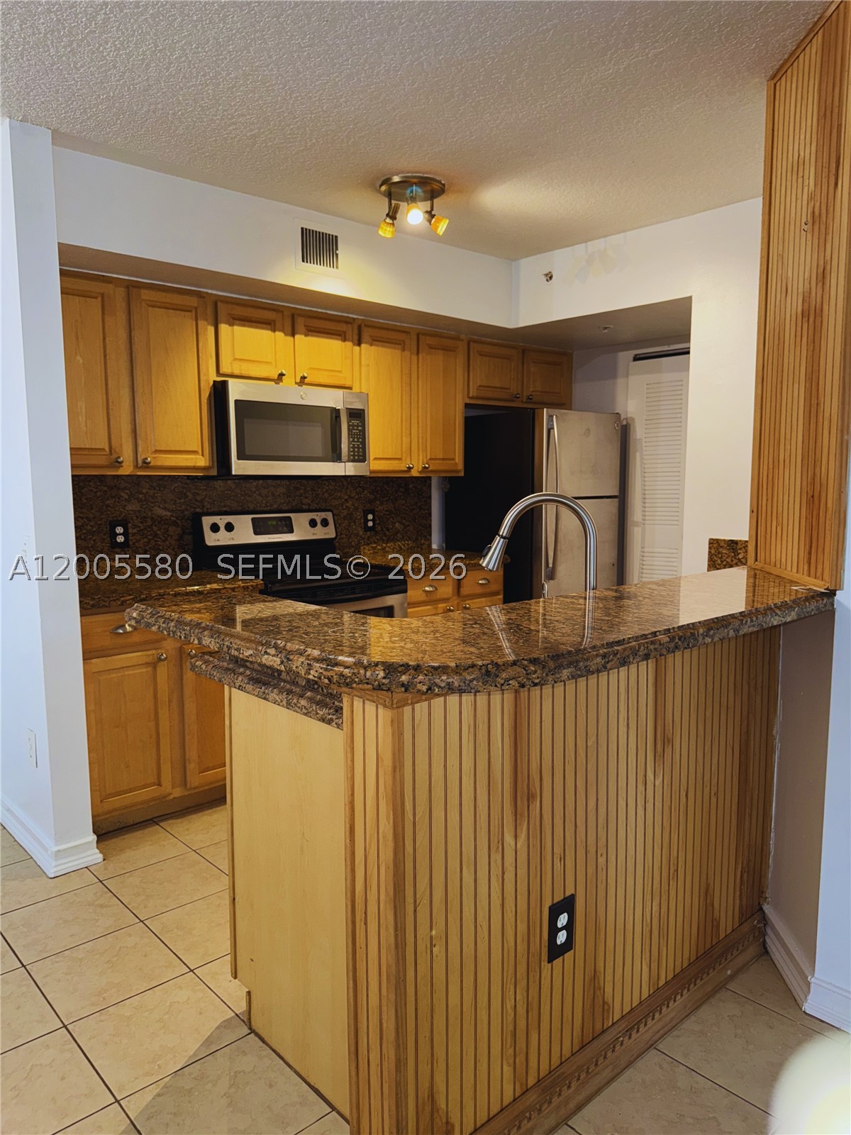 Excellent value in this 2-bedroom, 2-bath first-floor condo located in the gated community of Pinehurst Club in Hollywood! This well-maintained unit features a desirable split-bedroom floor plan and tile flooring throughout. The spacious primary suite offers a large walk-in closet, and the renovated primary bathroom includes dual sinks and modern finishes. The second bedroom is generously sized with ample closet space.
The updated kitchen boasts granite countertops, light wood cabinetry, and stainless steel appliances, including a glass-top range, microwave, and refrigerator. Enjoy a screened patio with a full-size washer and dryer for added convenience.
Brand new air conditioning system and all appliances are included, making this home completely move-in ready.
Prime location, just steps from the community pool and gym, and minutes from downtown Hollywood, shopping, dining, major expressways, the beach, and Fort Lauderdale-Hollywood International Airport.