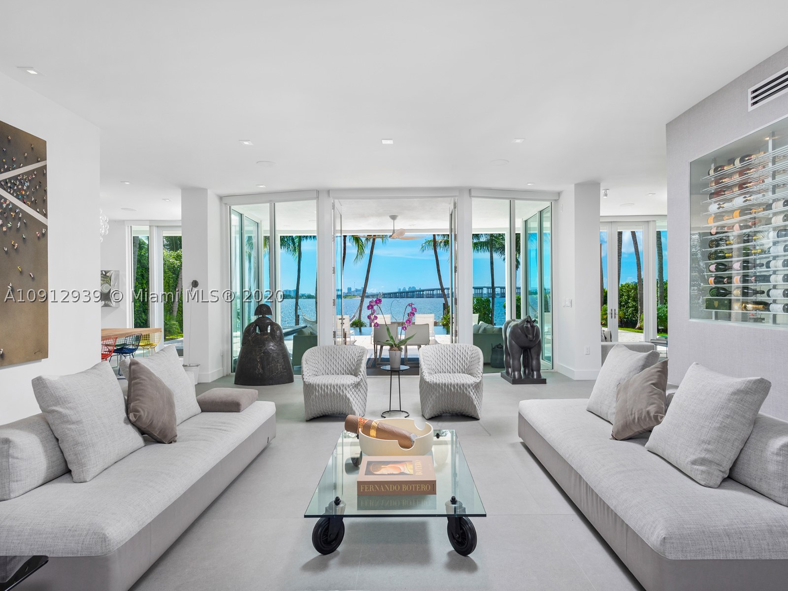 This stunning contemporary bayfront house in Miami’s exclusive Bay Point neighborhood has been completely renovated, including advanced reengineering to raise ceilings and create sweeping open spaces that take advantage of the unparalleled bay views. The southeastern exposure gives the house a truly tropical panorama, from the downtown Miami skyline all the way to North Beach, framed by swaying palm trees. The 6,553 square foot home offers five bedrooms, including a massive master suite with private home gym, at least two VIP suites, a pneumatic tube elevator, a climate-controlled wine cabinet, and a striking oculus over the front motor court. The home is exquisitely close to Miami’s booming Design District and Wynwood neighborhoods, as well as excellent private and magnet schools.