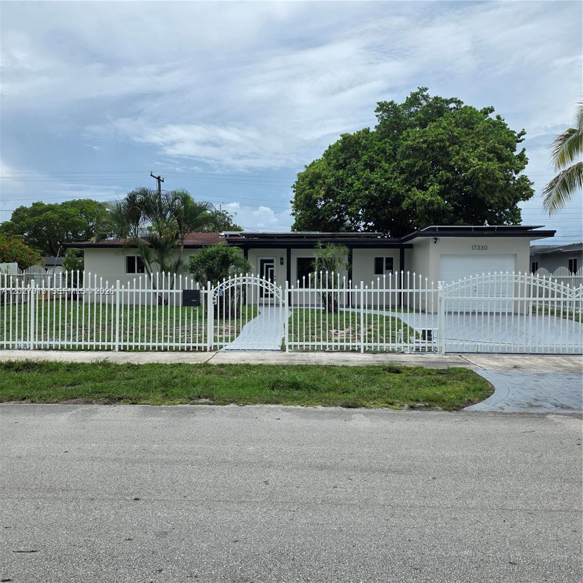 Exceptional move in ready 3 Bedrooms/2 Baths with fully paid 2023 solar panels. Impact Windows and doors, 2019 Roof, 2021 AC and HOA! Beautifully updated 1466 Sq Ft hone in Prime area of Miami Gardens featuring a modern kitchen with Quartz Counter Top and Brand New Stainless Steel Appliances. Elegant Porcelain floors throughout. Tankless Water Heater plus a large 1 car garage adjacent to an oversized laundry/flex room with separate entrance, ideal for extended family, guest space, home office or additional living use. Fully paid solar system transfers to buyer at closing providing valuable energy savings. Motorized metal Gate with remote control access to tastefully designed Driveway. Big lot with fruit trees and Room for pool.