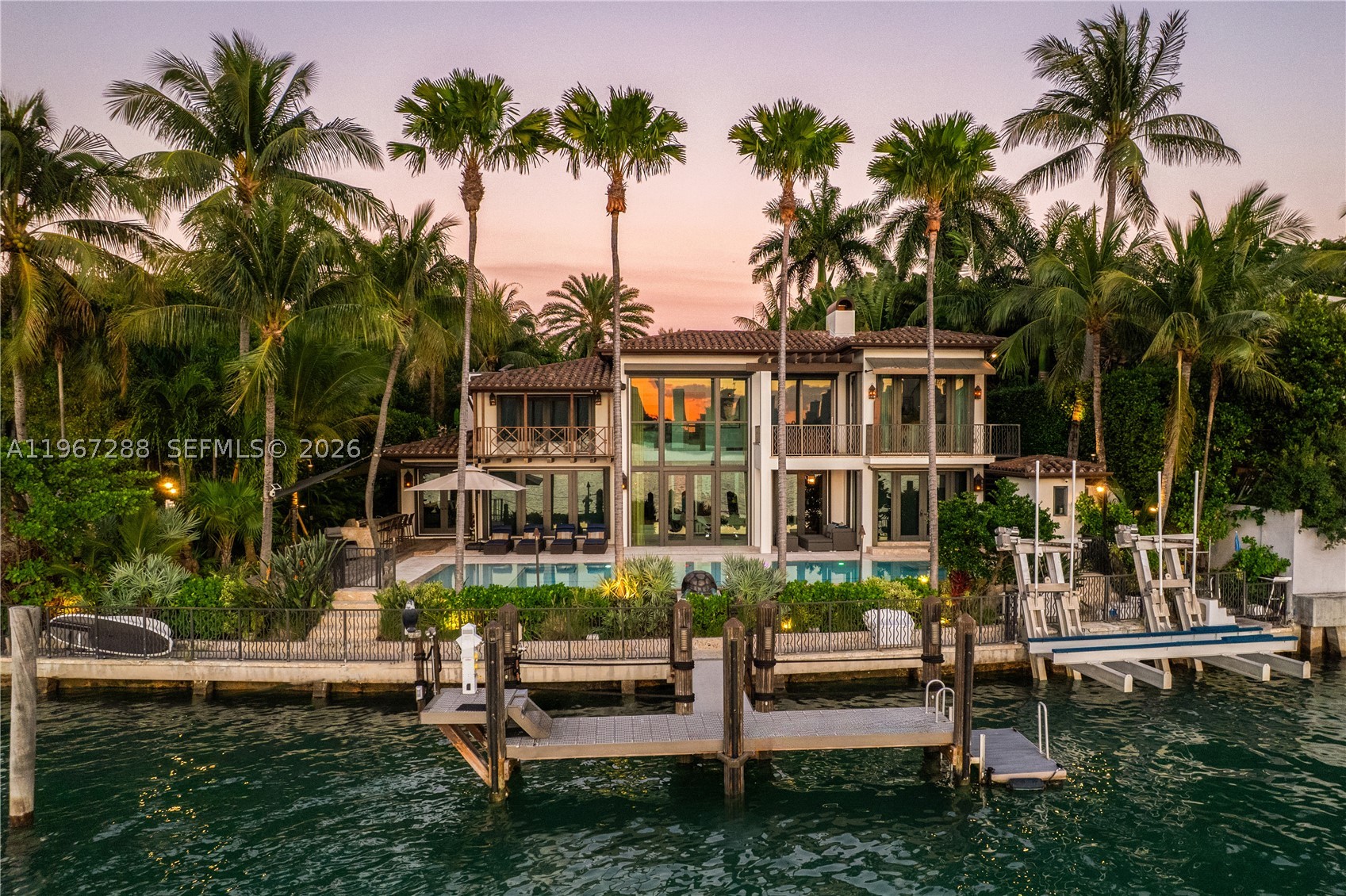Casa Mare is a masterfully reconstructed waterfront estate on the Venetian Islands, offering the pinnacle of direct open-bay & Downtown skyline views with spectacular sunsets. Arrive to tropical gardens, koi ponds, water features, and a meditation/yoga deck. 22-ft ceilings welcome you in the living room, with detailed finishes throughout - French oak and travertine floors, brass inlay doors, and pearled Venetian plaster. Warm and serene, it blends Art Deco Mediterranean design with subtle Asian influences. Enjoy a heated pool, summer kitchen, and approx. 110’ of waterfront w/dockage for a 90’ yacht. Includes a generator, state-of-the-art A/V & security cameras, UV filtration system, onyx bar, gated entry, 2-car A/C garage with EV charger, primary balcony jacuzzi, & guest house.
