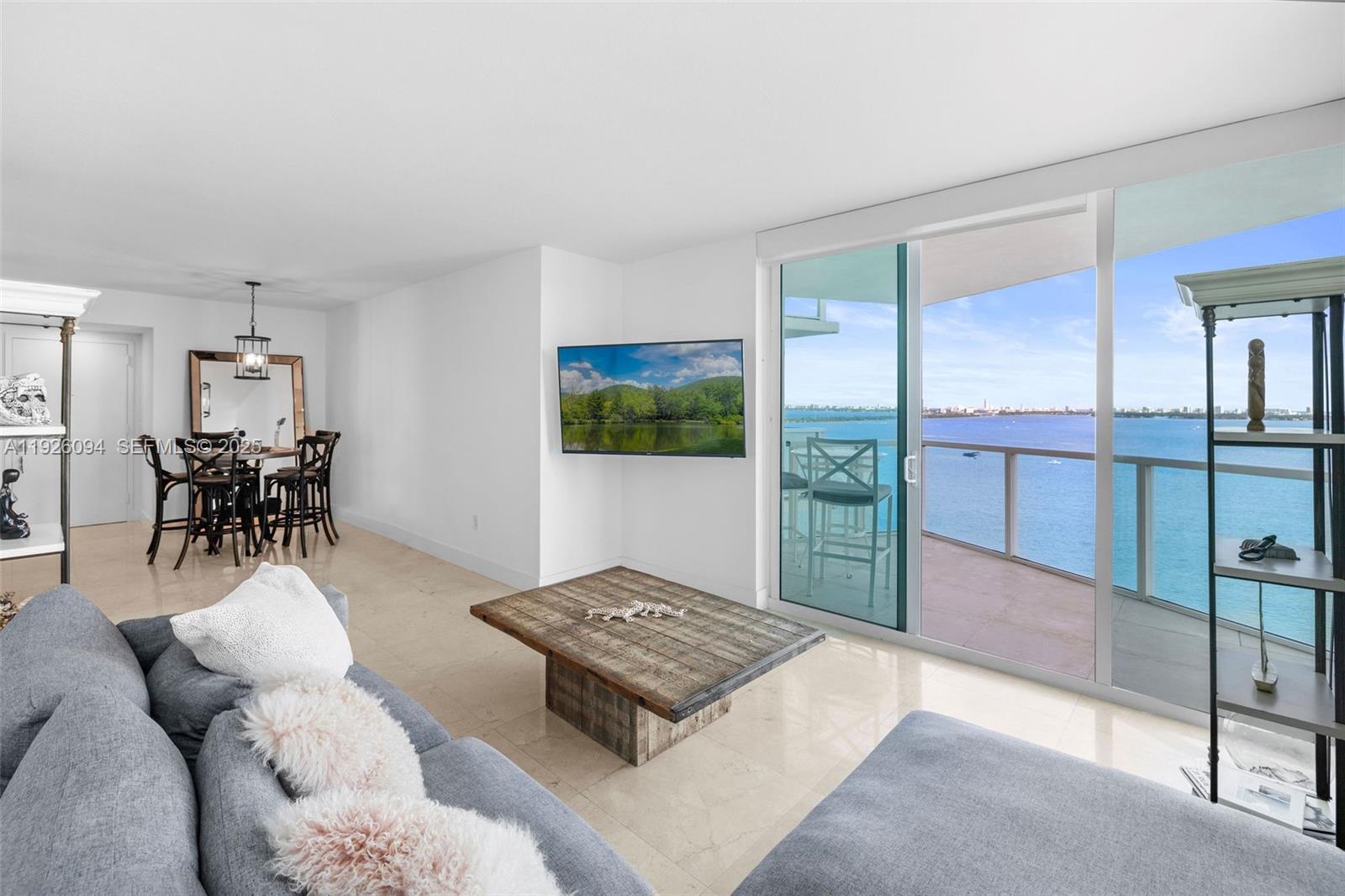 Bright corner 2-bedroom residence at Onyx on the Bay with bay and city views. Floor-to-ceiling windows fill the space with natural light, and a wraparound balcony offers sunrise and sunset views. Open layout with marble and wood floors, modern kitchen with stainless steel appliances, split bedroom plan, ensuite baths for both bedrooms, plus a guest powder room. One covered parking space included. Full-service building with waterfront pool, fitness center, spa, sauna, steam room, and 24-hour concierge. Prime Edgewater location near dining, shopping, Midtown, and Wynwood.