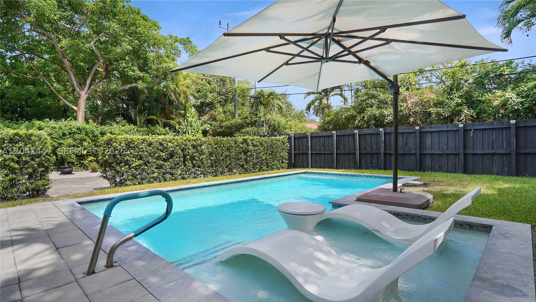 Own a neighborhood classic. Tucked at the end of a quiet, lush Miami Shores street — no through traffic, just neighbors and oak canopy. A midcentury home full of character, with the red flash of cardinals often crossing the branches above. 3bed/2baths, almost 1,700 sq ft on a 9,075 sq ft lot. Saltwater pool added 2022.  A 1949 fireplace anchors the living room as a decorative centerpiece — original to the home, kept for its beauty. Updated kitchen with stainless steel appliances, granite countertops, and a generous pantry. Paver parking in front; rear alley access through automatic gates leads to a two-car garage and an additional parking pad for multiple vehicles. Lush, private backyard for hosting or quiet evenings alike. Close to Miami Shores Village, Miami Shores Country Club, schools, restaurants. Close proximity to Biscayne Bay, Bal Harbour, Downtown Miami, and Miami Airport. A rare offering in one of Miami's most desirable neighborhoods.