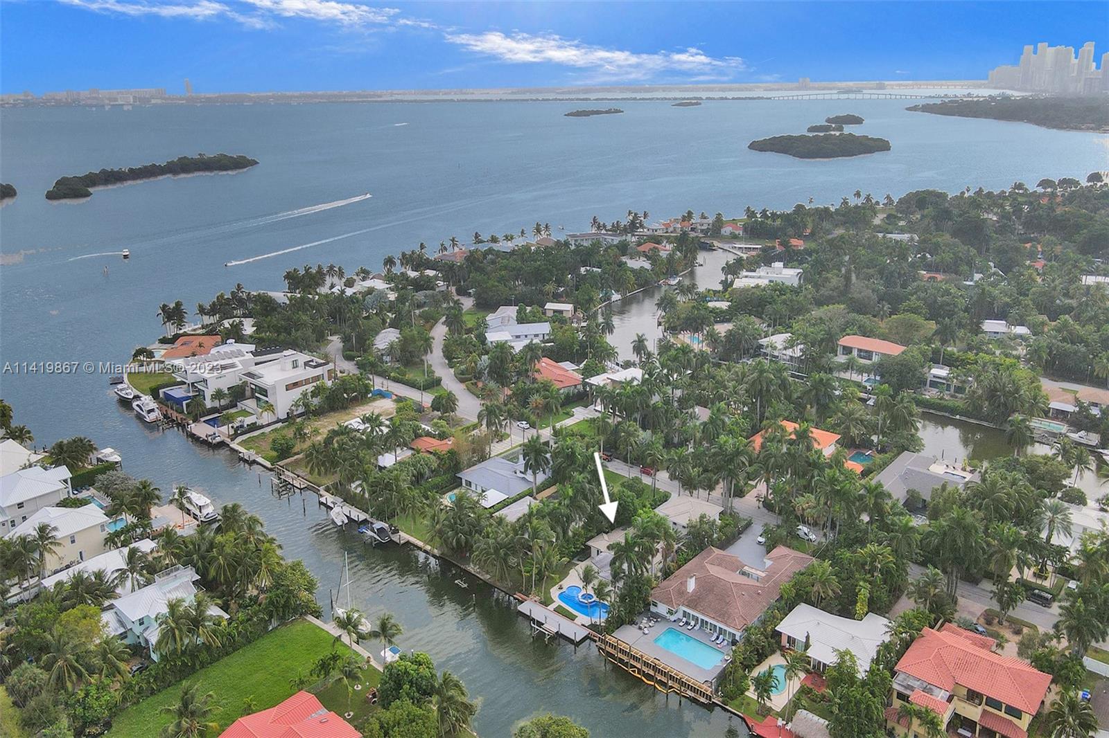 A waterfront opportunity rarely seen in a prime location. This one of a kind property located in the double gated community of Belle Meade Island is a few homes from the open bay with quick ocean access! Gorgeous 5 bdrm, 4 bath ultra modern home featuring a 3 car garage, state of the art movie theater with kitchen and full bath, 2 master suites, heated pool, and hot tub. Fully Intergrated smart home with a full security system. Natural light floods entire home throughout. This property offers a large open kitchen (great for any chef), full house generator, impact windows & doors, dock w/boat lift, and more. Home can be easily converted into 6 bedrooms, if needed. Sitting on 12,300 SqFt w. lush landscaping and 75 Ft of water frontage - great for any boater!