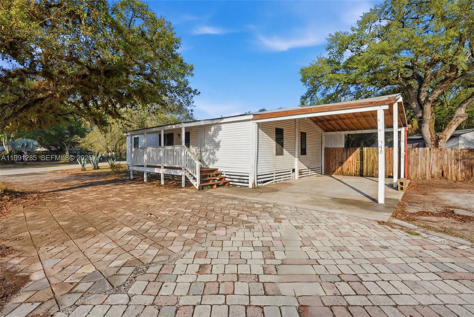 Located in the heart of LaBelle, this corner-lot property presents a prime opportunity for investors or buyers seeking a cash-only fixer-upper with endless potential. Featuring an extended paved driveway, covered carport, front porch, and a fully fenced yard with additional storage in the backyard, this property offers a solid foundation to bring your vision to life. Inside, the home offers an open living area and a functional kitchen layout. Natural light fills the space, and the layout provides a great starting point for renovations and updates. Conveniently located near local schools, shopping, and town amenities, this property offers both accessibility and small-town charm. Whether you’re looking to renovate and resell, create a rental, or design your own space, this is a great opportunity in a growing area.