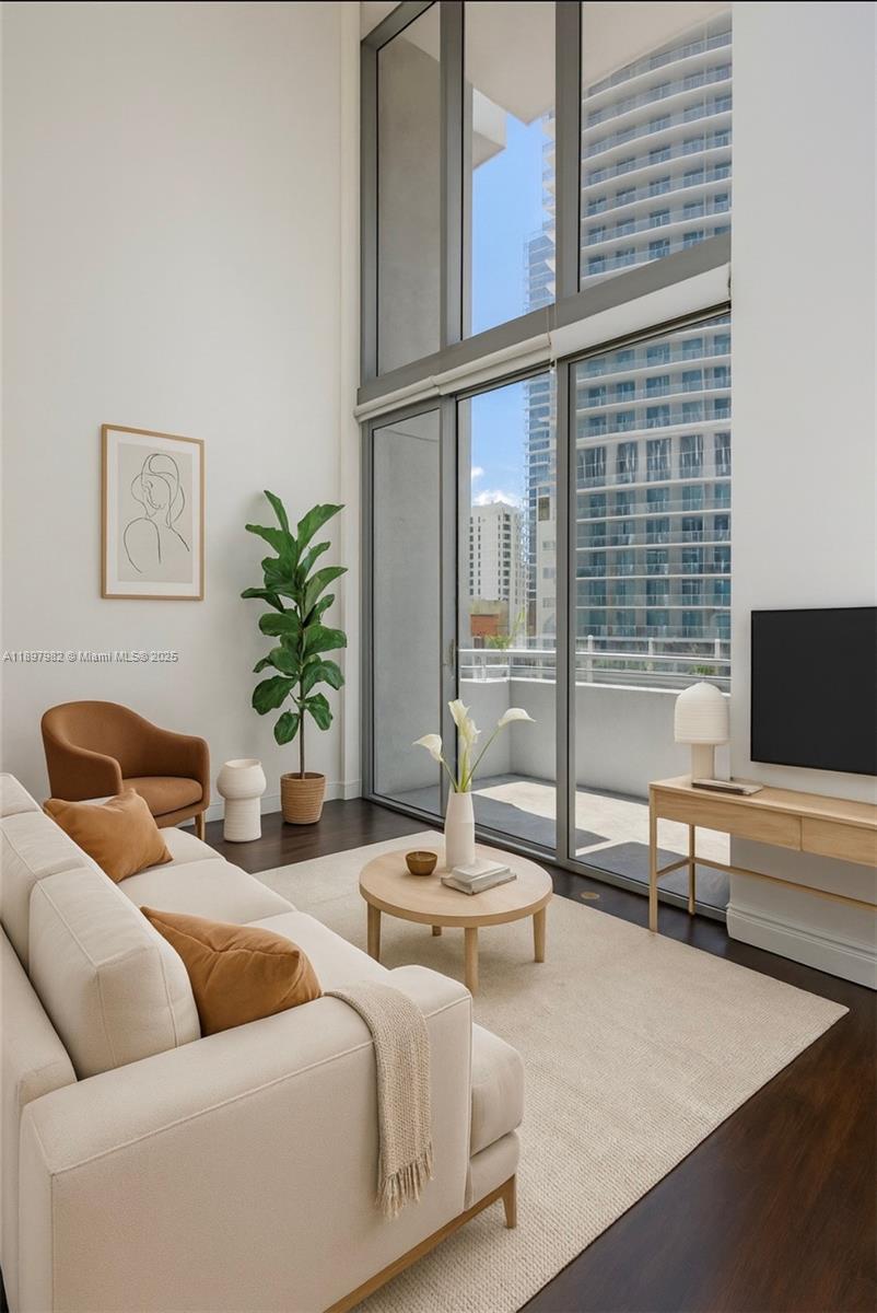 If you want the feel of a townhome(duplex) in the heart of the city, take advantage of this opportunity to own a rare large 2-story loft townhome w/ 20 feet soaring ceilings and windows on a lower floor with large balcony and city view, best building and location on Brickell Ave. Home features 1 large bedroom upstairs plus a small den area for office and 2 full bathrooms.A full bath with bathtub/shower combo upstairs and a full bath with shower on the main level for your overnight guests.Features partially open kitchen,still separate from living room area to allow for wall space, furnishings and privacy.Unit features wood laminate flooring throughout with modern kitchen and baths.Building amenities include 2 pools,gym,sauna,recreation areas,business center, Valet Parking,doorman security.