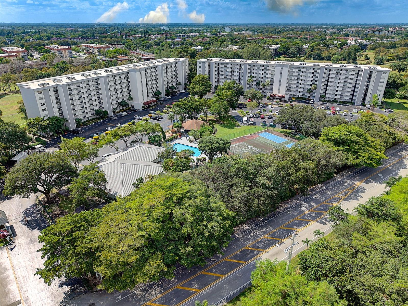 Enjoy scenic views of what was once an active golf course from your private balcony—accessible from both the living room and the primary bedroom. This meticulously kept 2-bedroom, 2-bath home offers generous living spaces filled with natural light, plus the convenience of an in-unit washer and dryer and parking located right in front of your unit. Hi-Greens is known for its lush greenery and scenic walking trails, and as a 55+ community, it offers amenities including pickleball and tennis courts, pool, a clubhouse, and peaceful nature paths to enjoy year-round. 40 Year Inspection has been completed and assessments have been paid in full. Sellers are willing to leave all of the furniture.