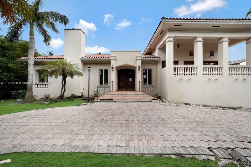 This great house is located on a Cul-De-Sac in Cocoplum. Features include: Beautiful double entry door, 6 Bedrooms, 5 1/2 Baths, interior "Hacienda Style" garden, gourmet kitchen, volume ceilings, exquisite wood doors, custom closets, heated pool and spa, great covered area for entertainment, 2 car garage, paved circular driveway, all on a big 19,948 sq ft lot! Property is being sold via Auction on Xome.