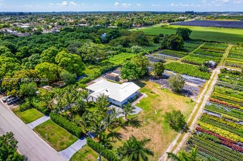 location, location, location... EAST REDLAND THE UDB IS LOCATED EAST SIDE ON 137 AVENUE WE ARE 13770. LAND BANKING IS STRONG POSSIBILITY.THIS IS AN AMAZING STREET DIVERSIFIED WITH  AGRICULTURAL PROPERTIES TO INCLUDE ESTATES, HUGE HI END WALLED COMPOUNDS CURRENTLY BEING BUILT, ORGANIC PRODUCE, FRUIT TREES AND GARDENS, AND OF COURSE A SELECTION OF EQUESTRIAN FACILITIES. THIS AGRICULTURAL COMPOUND IS SITUATED ON 5.5 ACRES. SHES A 4/3  SPLIT PLAN W PORTE COCHERE THE HOME PLACEMENT ALLOWS MAX LAND USAGE. (FRONT AND CORNER) ELEC GATES ALLOW ENTRY INTO THE SEPERATED EACH APPROX 2.75- THE CROSS FENCING SEPERATES THE LAND INTO 2 PARCELS OF USAGE.BOTH WITH PRIVATE ENTRYS. THE WEST FORMER NURSERY,.CURRENT MONTH TO MONTH TENANT., ALSO HAS ASST FRUIT TREES ON SITE. SHES A BEAUTY AGAIN THE LOCATION IS A PLUS TIN REGARDS TO TRAVEL TIME AND FUTURE GROWTH POSSIBILITIES.