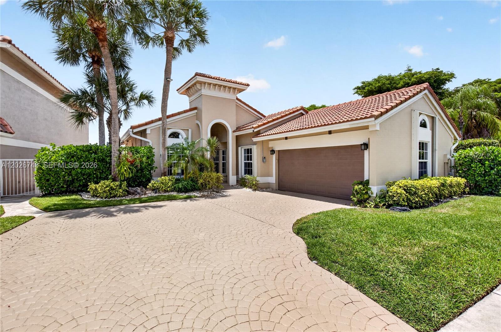 Experience the ultimate South Florida lifestyle in this fully renovated, move-in-ready lakefront home designed for modern living and effortless entertaining. Thoughtfully remodeled from floor to ceiling, this residence blends luxury, comfort, and functionality with a bright open-concept layout and seamless indoor/outdoor living.

The heart of the home is a stunning chef’s kitchen featuring quartz countertops, oversized waterfall island, premium stainless steel appliances, custom cabinetry, and elegant designer finishes throughout. Vaulted ceilings, impact windows and doors, marble bathrooms, travertine flooring, and abundant natural light create a sophisticated yet welcoming atmosphere. An additional split A/C system provides enhanced comfort and climate control year-round. Additional upgrades include electrical readiness for EV charging.

Step outside to your private lakefront backyard retreat with a brand-new heated pool, the perfect setting for entertaining guests, family gatherings, or simply enjoying peaceful waterfront views year-round.

The home also offers additional flexible space ideal for a gym, office, playroom, media room, or extra storage.

This turnkey property offers the ideal combination of modern design, resort-style living, and everyday practicality, all located within the exclusive Villaggio community, a boutique West Boca neighborhood with only 35 residences.