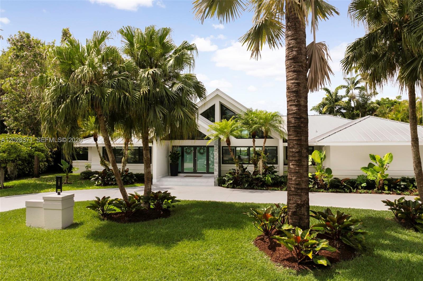 Set on a lush, nearly 17,000-square-foot lot in one of Pinecrest’s most desirable enclaves, this beautifully renovated residence offers privacy, elegance, and effortless living. Featuring 5 bedrooms, 3.5 bathrooms, and over 3,700 square feet of thoughtfully designed interiors, the home balances timeless appeal with modern updates. Expansive living spaces flow seamlessly to the outdoors, where mature landscaping creates a tranquil backdrop for entertaining and everyday enjoyment. The updated kitchen, spacious family areas, metal roof, gated entry, and two-car garage enhance both comfort and functionality. Ideally positioned near Pinecrest’s premier schools, parks, and conveniences, this exceptional property presents a rare opportunity to enjoy the best of Pinecrest living.