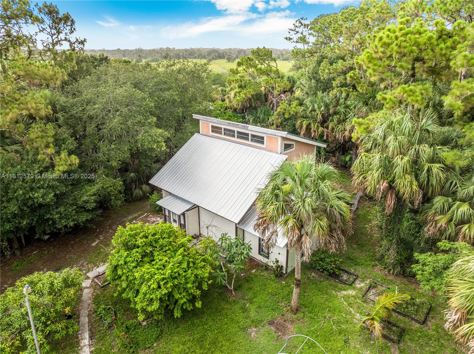 Escape to your private retreat in Indiantown, FL! This beautifully updated 3-bedroom, 2-bathroom home sits on nearly 5 serene acres and offers 1,689 sq. ft. of stylish, move-in-ready living space—just one hour from Palm Beach International Airport. Renovated in 2022, the home boasts a sleek metal roof, a modern kitchen with updated appliances, a new A/C system, and thoughtful upgrades throughout.

Step outside to enjoy your own private pond, a spacious 600 sq. ft. detached garage with a separate electric meter, and a barn ready for animals, storage, or creative projects. A whole-home generator ensures peace of mind year-round.

This property offers the perfect balance of privacy, space, and convenience. Showings by appointment only, 24 hr notice.