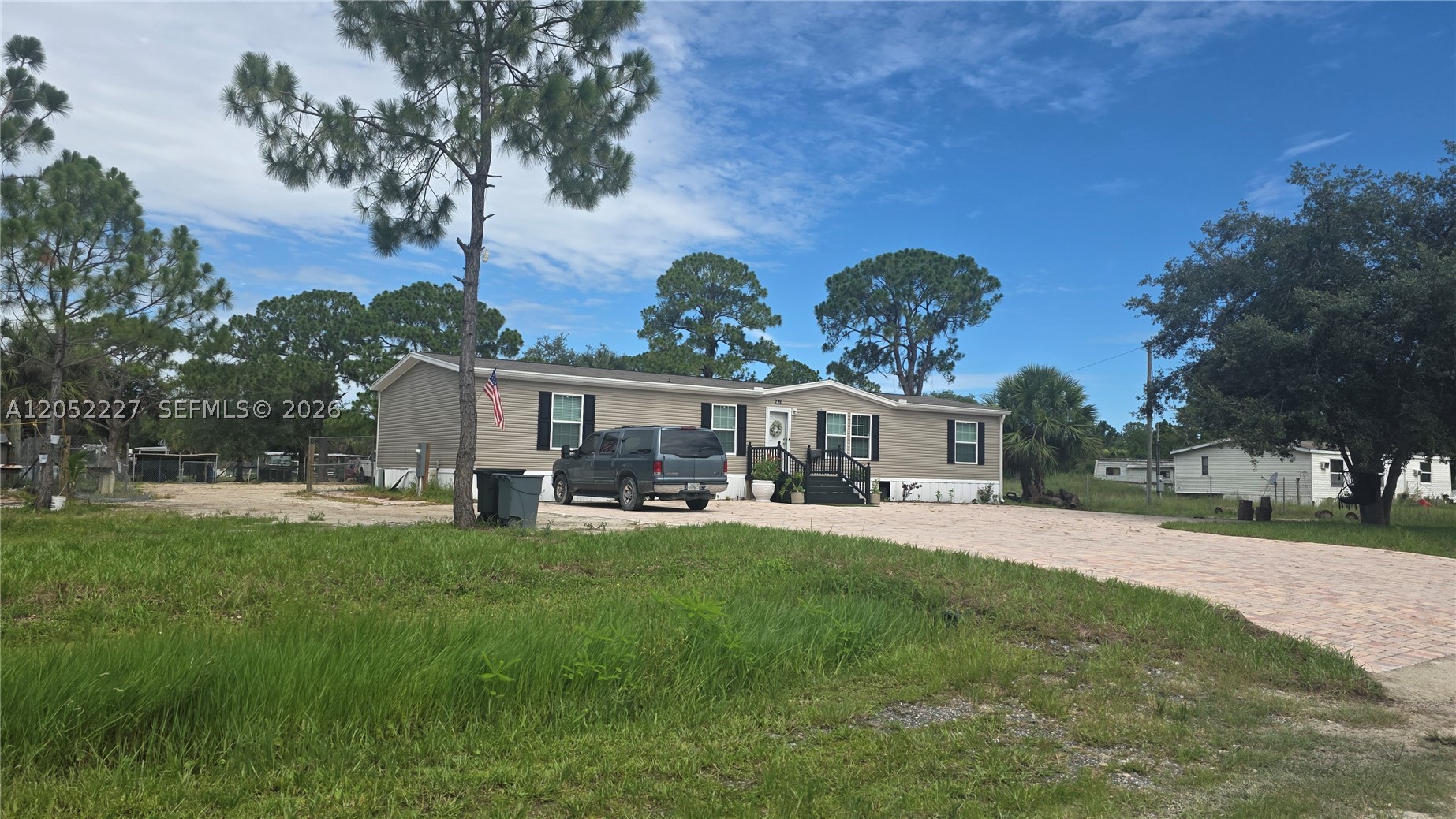An excellent opportunity. A 2025 model manufactured home located in Montura Ranch Estates. Situated on a private 1.25-acre lot, this property offers 1,800 square feet of living space, featuring a spacious living room, a Florida room, four bedrooms, and two bathrooms.
Outside, there is a large, covered wooden lanai/deck—ideal for enjoying the peaceful surroundings and outdoor space—as well as an above-ground pool for cooling off on warm Florida days.
The front of the property features a spacious paver driveway that covers the entire front area and extends to the street, providing ample parking for multiple vehicles.
The property is fenced on all sides except the front and includes well-organized outdoor areas—such as front and back yards—along with partitioned sections and pens ready for animals. There is also a beautiful paved area shaded by a tree and furnished with outdoor seating, creating the perfect spot for gatherings, relaxation, and outdoor entertaining.
Located in Montura Ranch Estates, a rural community in Hendry County situated between Clewiston and LaBelle, offering convenient access to various South Florida cities.