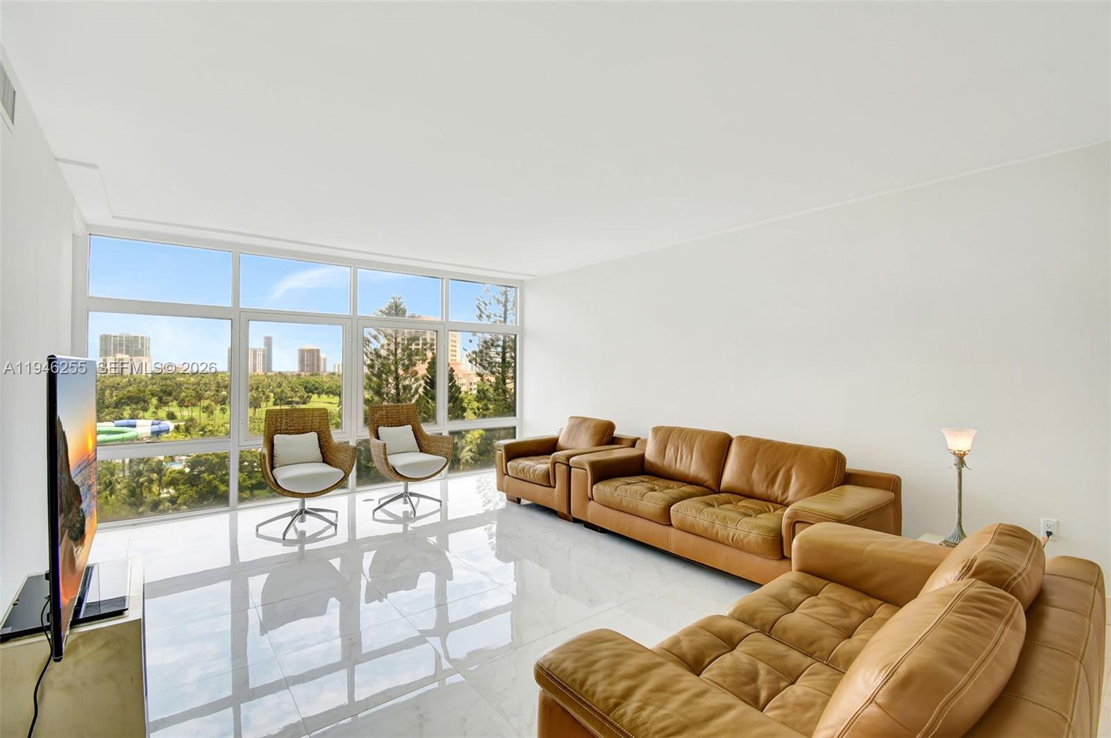 Beautiful corner unit at Bonavida Condo in Aventura, offering 1,308 sq. ft. of living space with 2 bedrooms and 2 bathrooms. Enjoy majestic views overlooking the Turnberry Isle golf course with Sunny Isles Beach as a stunning backdrop. The building features excellent amenities, including a swimming pool, gym, billiards room, club room, and on-site management. Step outside and enjoy the scenic 3-mile walking path around the golf course, located just steps from the building. Conveniently situated across the street from a plaza with a supermarket, pharmacy, restaurants, and direct access to Aventura Mall. Minutes from Waterways Plaza, the marina, beaches, Gulfstream Casino, universities, hospitals, and many other points of interest.