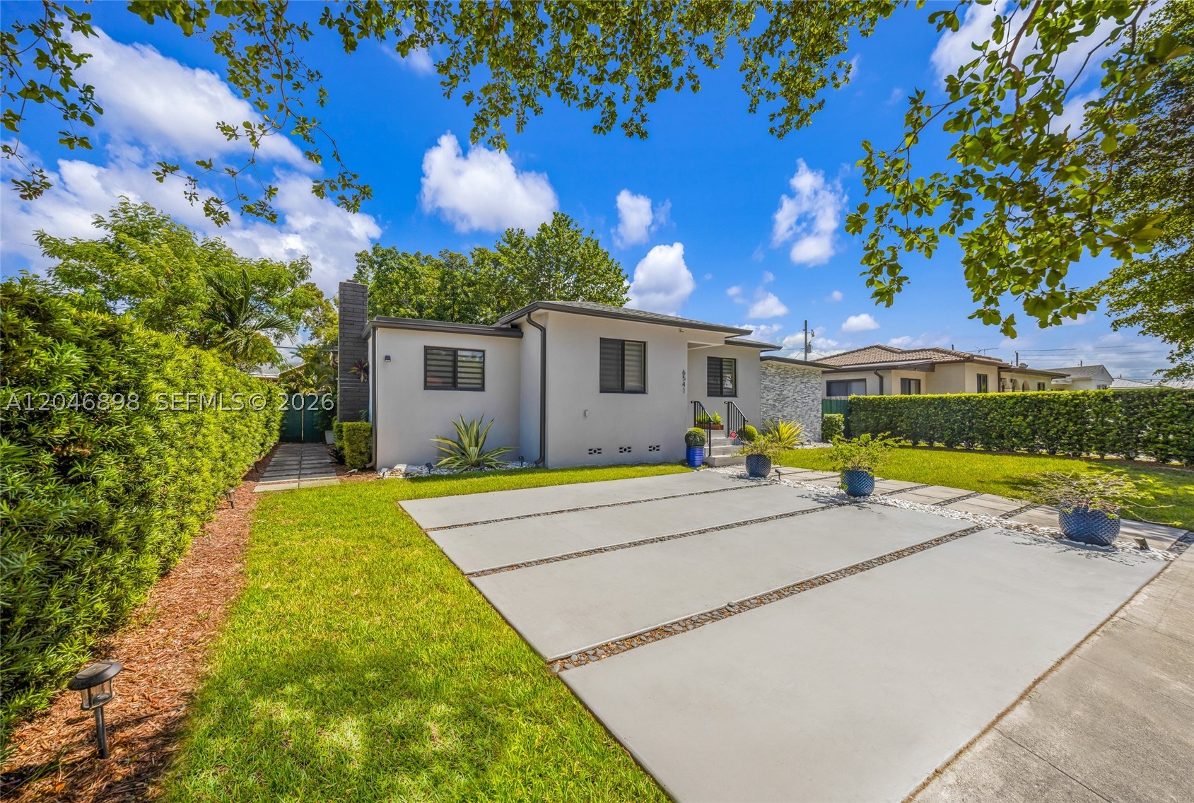 BEAUTIFUL HOME,TOTALLY REDONE WITH HIGH END FINISHES, GREAT LOCATION, 2 BEDROOMS PLUS A DEN, 2 FULL BATHS, VERY LARGE FAMILY ROOM, HIGH CEILINGS, HURRICAN PROOF SLIDING DOOR AND WINDOWS, NEW AC UNIT, ROOF FROM 2018. RENOVATED KITCHEN WITH QUARTZ COUNTER TOPS AND STAINLESS STEEL APPLIANCES, LAUNDRY ROOM, GREAT FENCED BACKYARD **PRICED RIGHT**
