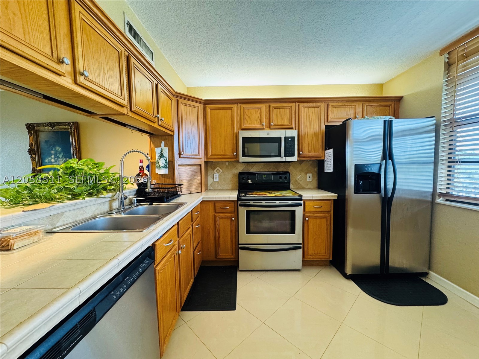Spectacular 2/2 with 1385 sq ft and Water View available in the Desirable area of Pine Island Ridge! Kitchen is updated and Primary Bedroom has a spacious closet with built-in cabinetry, Tile and Laminate floors. Unit also has additional room that can be used as an office/3rd room or storage area. Laundry room is inside the condo with full size washer/dryer. Development has golf course, multiple pools and is located in the Private Pine Island Ridge County Club with Exercise room, 2 restaurants, basketball courts and more. All age Community close to NOVA Southeastern University, Shopping, Dining, Entertainment, FLL, and easy access to major highways. This is a must see!