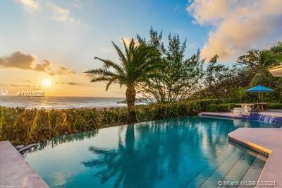 Built in 1950, this 6-bedroom, 5.1-bath, 3-car garage oceanfront residence has been lovingly maintained throughout the years preserving the timeless elegance of a true Jupiter Island estate. Behind the tall hedges and lush tropical landscape lies a special property spanning approximately 1.46 acres with over 130 feet of direct ocean frontage. Ultimate privacy and seclusion are provided by its over 400 feet of depth. Perched above the dune, the residence offers spectacular beachfront views from the main living areas and splendid places for formal gatherings or casual entertaining.  An elevated courtyard entrance welcomes one inside to over 6,000 square feet of sophisticated spaces and comfortable private areas for family and guests.