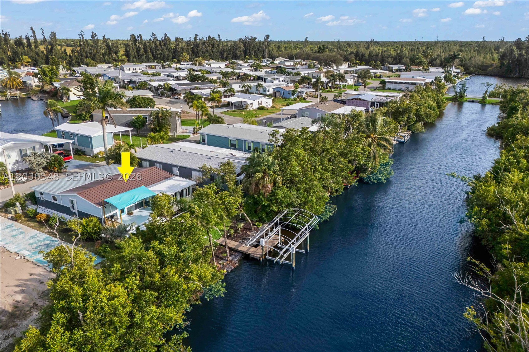 WELCOME TO YOUR WATERFRONT ISLAND PARADISE on Pine Island! Located in the highly desirable 55+ boating community of Pine Island Cove, this beautifully updated, move-in-ready waterfront home offers the ultimate Southwest Florida lifestyle. Featuring 2 bedrooms, 2 baths, a private dock, and 10,000-lb boat lift, you'll enjoy direct boating access to Pine Island Sound, Matlacha Pass, Sanibel, Captiva, Cayo Costa, Boca Grande, and the Gulf. Inside, the bright open floor plan is filled with natural light and showcases peaceful canal views, vinyl flooring, coastal finishes, updated fixtures, and spacious living and dining areas perfect for entertaining. The kitchen offers ample cabinetry, stainless steel appliances, generous counter space, and breakfast bar seating. The primary bath features a stylish double-sink vanity, while both bedrooms provide comfortable accommodations for owners and guests. Step outside to your private waterfront retreat with a composite deck and shade sail, ideal for relaxing, dining, or enjoying stunning sunsets. Tropical landscaping and mature palms create privacy and a true island oasis. Residents enjoy exceptional amenities including a pool, clubhouse, pickleball courts, dog park, boat ramp, boat storage, and year-round social activities. Golf-cart friendly and close to marinas, waterfront dining, art galleries, farmers markets, and world-class fishing. Live where others vacation!