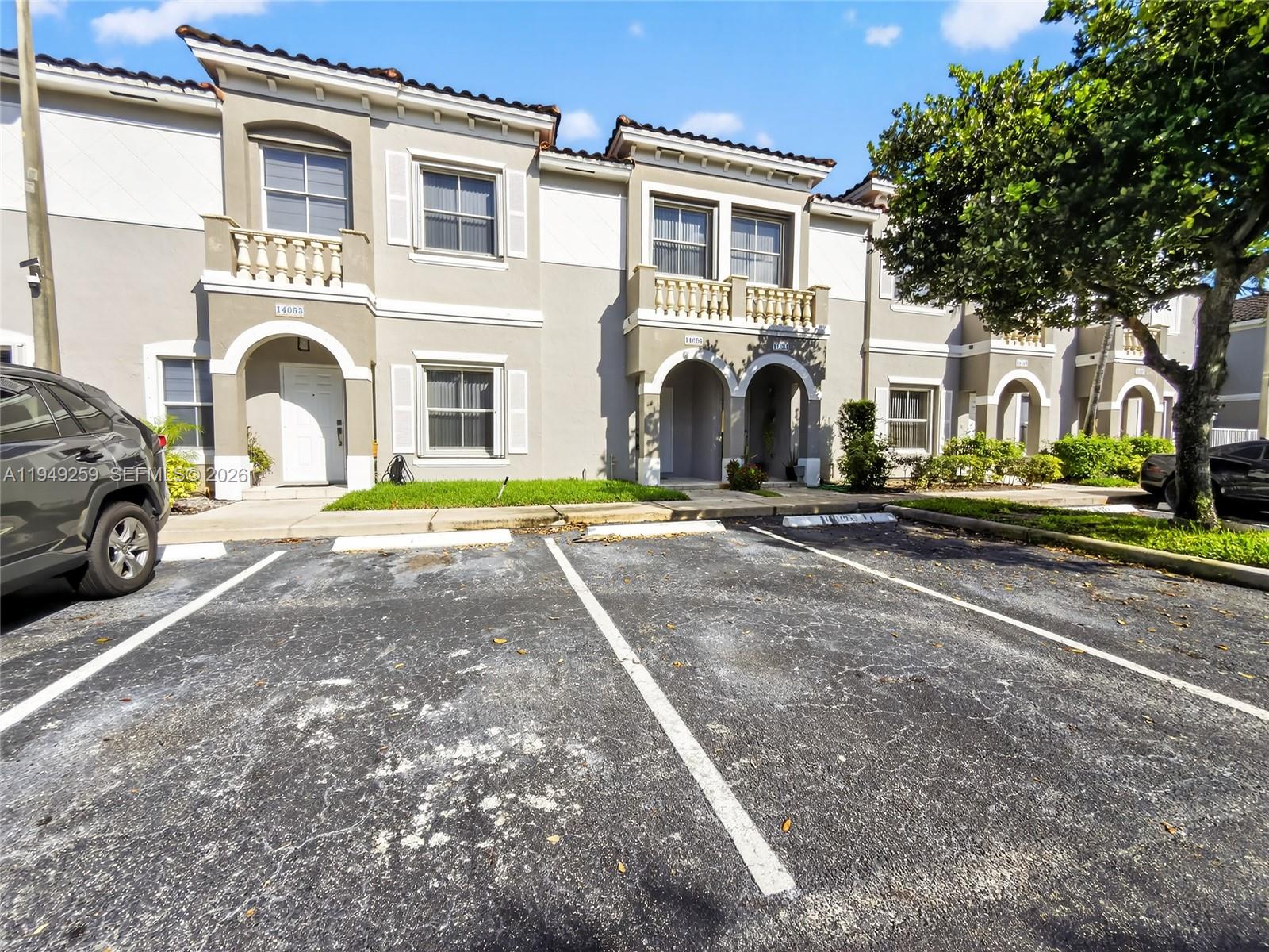 Move-in-ready townhouse located in the gated Vizcaya community, offering two convenient parking spaces directly in front of the unit. The home is filled with natural light and features tile flooring throughout both the first and second floors. The open-concept kitchen is equipped with stainless steel appliances and flows seamlessly into the family room, making it perfect for everyday living and entertaining. The living and dining areas connect effortlessly, creating a spacious layout. Upstairs, both bathrooms have been updated with modern glass shower doors. The oversized primary bedroom includes a walk-in closet. Hurricane shutters are included for added security and peace of mind.