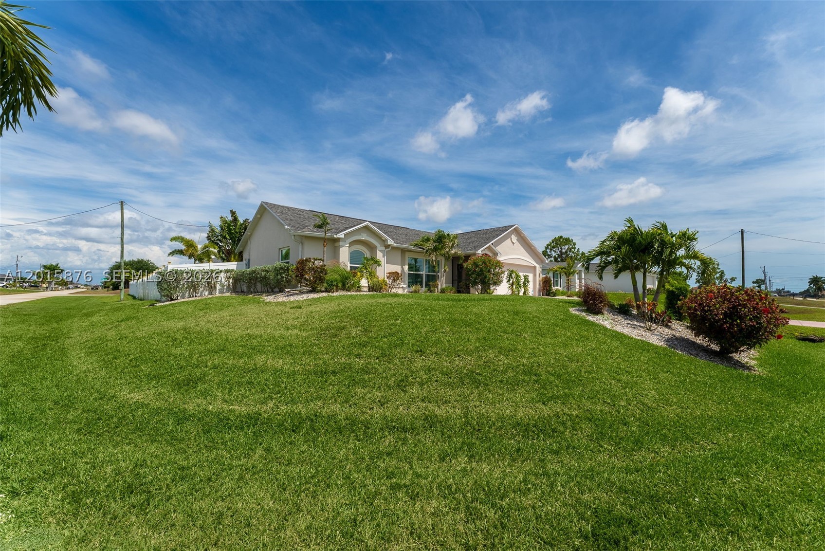 Welcome to your own slice of Florida paradise! Situated on a spacious corner lot, this stunning home offers extra privacy, a larger yard, and the resort-style outdoor living Southwest Florida buyers love. Lush tropical landscaping and a screened front entry create a warm first impression, while inside, the bright open floor plan is filled with natural light and flows seamlessly into the kitchen featuring newer appliances, including an induction stove and dishwasher. The split-bedroom layout provides privacy for the primary suite and guest rooms, and the interior laundry room includes a newer washer and dryer for added convenience. Designed for true indoor-outdoor Florida living, the open lanai is perfect for relaxing or entertaining, highlighted by a ceiling-mounted TV that lowers and swivels 360 degrees for viewing from nearly anywhere on the patio. The backyard feels like a private tropical retreat with a newer saltwater pool, pavered pool deck, plenty of lounge space, and a huge PVC-fenced yard. Additional upgrades include impact windows and doors, plantation shutters, Bluetooth music/fan feature in the primary bathroom, Bluetooth LED patio lighting, exterior accent lighting, and thoughtful details throughout. With its private corner lot, resort-style pool area, open layout, and extensive upgrades, this home truly delivers the Florida lifestyle you’ve been waiting for.