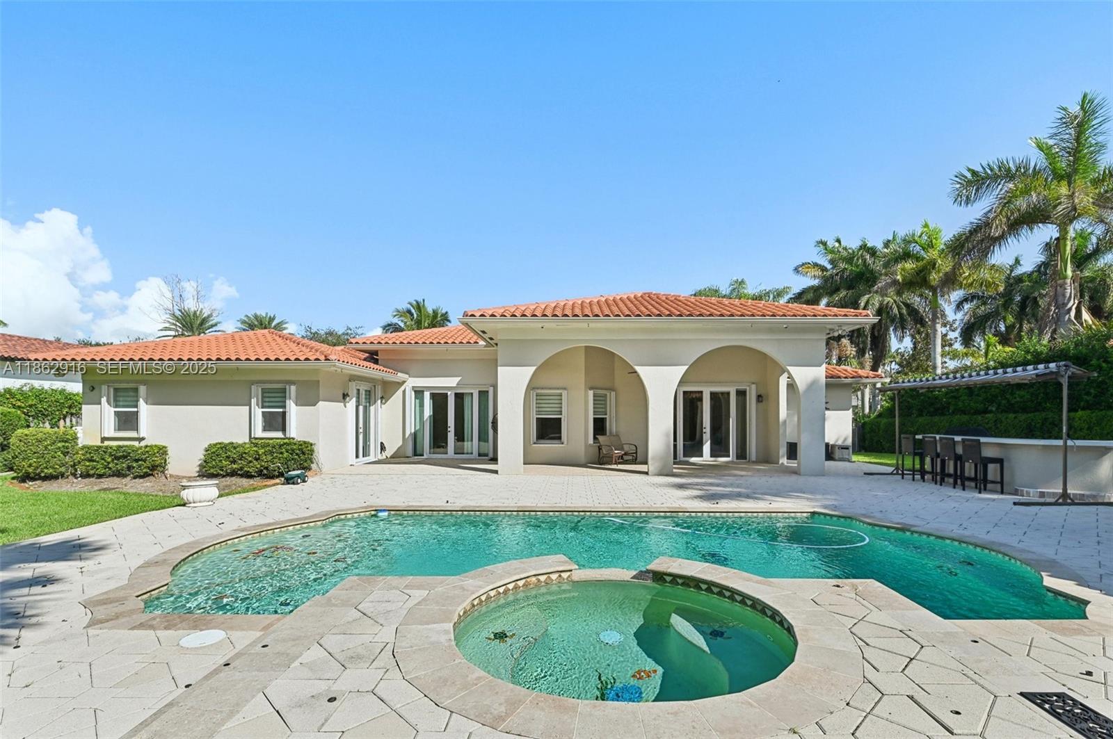 RARE .42-ACRE PALMETTO BAY PROPERTY featuring soaring ceilings, full hurricane protection, and a whole-home generator with a buried 500-gallon propane tank. This 4-bedroom, 4-bath residence offers 3,036 sq ft under air and blends modern comfort with true South Florida indoor–outdoor living.

Step inside to a bright, open layout with 12-ft ceilings, large impact doors, and natural light throughout. The chef’s kitchen is fully upgraded with top-of-the-line appliances, custom cabinetry, premium counters, and a large island perfect for entertaining. The primary suite features a spa-style bath, dual vanities, a frameless glass shower, and generous closet space.

Four large bedrooms, offering privacy for family and guests. A separate living and dining area provides multiple gathering spaces, while the split-bedroom layout offers ideal functionality.

Outside, enjoy a tropical backyard oasis with a resort-style pool, entertainment-ready patio, and a complete outdoor kitchen—perfect for family living and year-round gatherings. The oversized lot offers room to play, garden, or expand.

This is a rare opportunity to own a highly upgraded, storm-ready home on one of Palmetto Bay’s larger lots—near top-rated schools, parks, and the best of the Village.