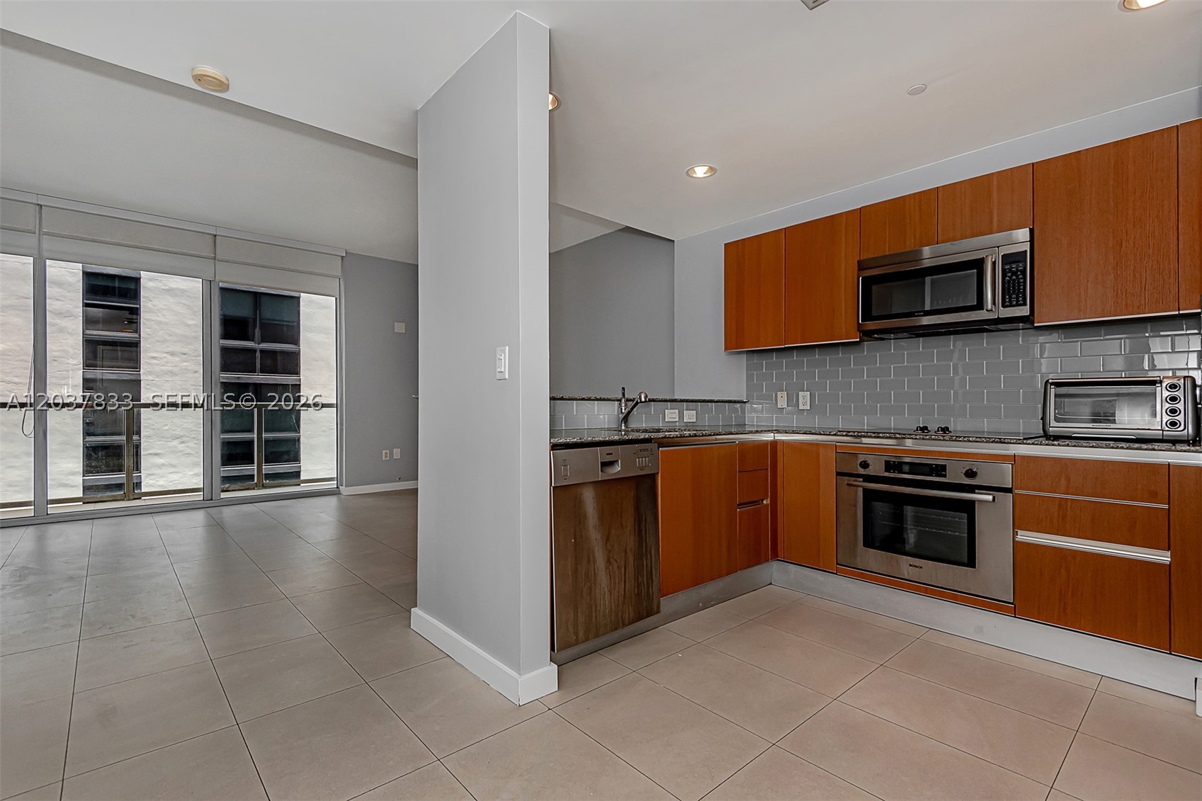 Beautiful studio residence in the 1050 Brickell building featuring stunning views of the Brickell skyline. The unit offers modern finishes and appliances, a custom high-end closet build-out, and a spacious bathroom with a marble shower stall. Tile flooring and wood cabinetry enhance both the kitchen and bathroom. Washer and dryer are conveniently located inside the unit. Basic cable is included through the HOA.