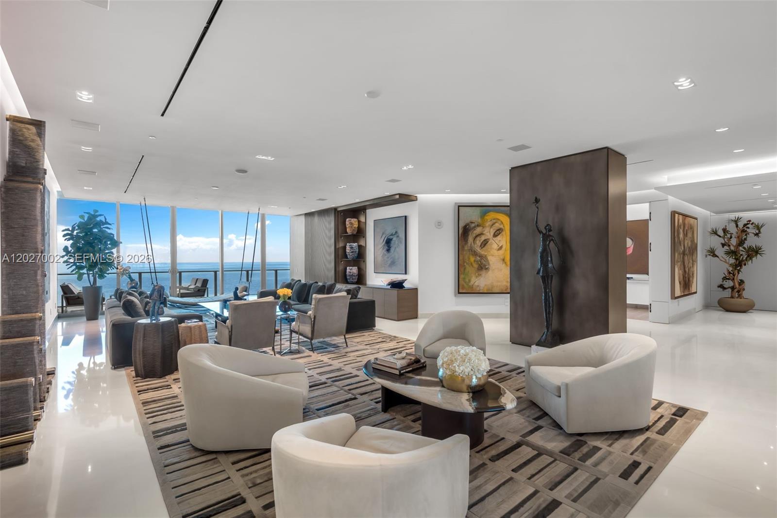 Lower Penthouse 2N at Oceana Key Biscayne presents a rare opportunity to own a meticulously curated, fully remodeled sky residence in one of South Florida’s most exclusive boutique oceanfront communities. Spanning nearly 6,000 SF of total living area including interior + expansive terraces, this exceptional flowthrough home showcases breathtaking ocean, beach, bay, skyline, and Miami Beach views while capturing both spectacular sunrises and sunsets. Thoughtfully reimagined with exceptional attention to detail, the residence blends sophisticated design with effortless functionality. Soaring 11-ft ceilings, rich custom millwork and designer wall coverings, integrated architectural lighting, built-in audio, Crestron smart home automation, custom built-ins, and bespoke finishes throughout create an atmosphere of understated luxury. Designed for both intimate living and grand entertaining, the home features a private elevator foyer, hidden custom bar, elegant formal and informal living spaces, 4 spacious en-suite bedrooms, 5.5 bathrooms, laundry/staff quarters, & an exceptional sense of privacy throughout. Residents enjoy Oceana’s unmatched white-glove service and world-class amenities, including over 500 feet of pristine beachfront, resort-style pools, fitness center and spa, resident-favorite restaurant, tennis court, beach volleyball, and beautifully curated grounds. A truly extraordinary offering for the most discerning buyer. Includes 4 assigned parking spaces & 1 storage.