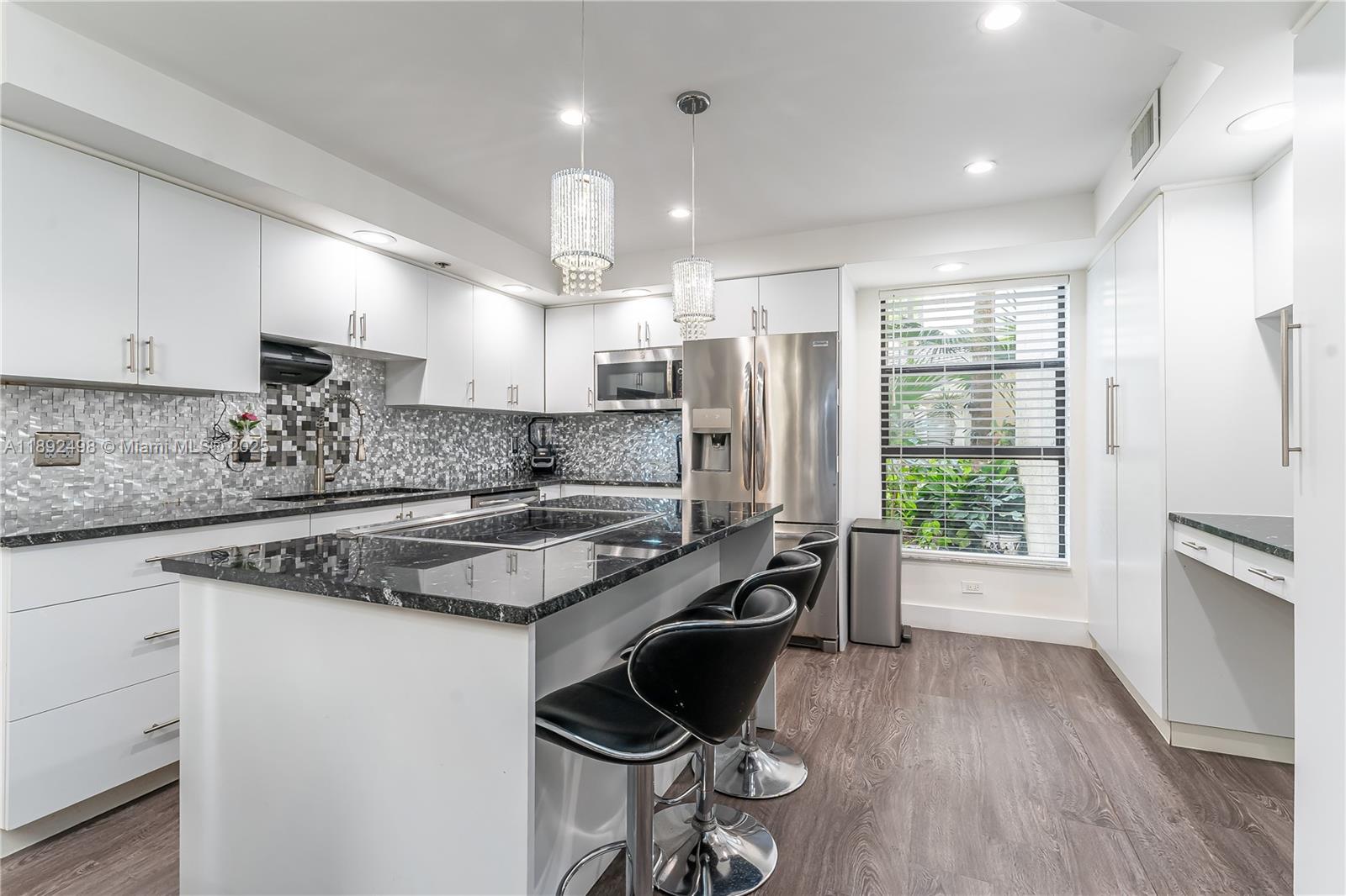 Stunning oversized corner-unit, two bedroom two & a half bath condo completely updated in a 55+ gated community!! One of the largest units in the complex on the first floor overlooking the pool!  Oversized kitchen with island & tons of cabinets.  Impressive foyer entrance leading into the large dining & living area.  Elegant lighting throughout, including recessed lighting in the living room! Primary bedroom has two walk-in closets, & the bathroom has double sinks, large shower & a roman tub. Full size washer/dryer in the unit as well.  Large wrap-around screened porch, with a private patio overlooking the pool & grounds!  Fantastic community, gated, with tons of activities.  HOA includes internet, cable, water, sewer, gym, pest control, heated pool, tennis & more! This unit will not last!