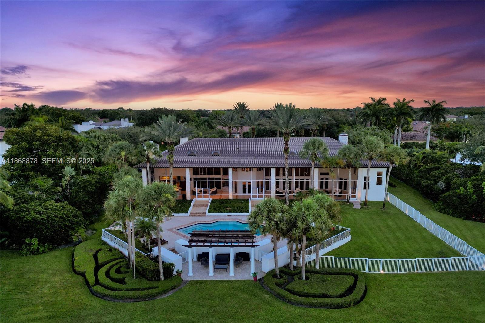 Discover timeless elegance in this Spectacular Custom Estate situated on a private cul-de-sac lot in the prestigious Windmill Ranch Estates. This residence offers over 8,600 sq ft of luxurious living area on a beautiful 1.32 acre lot. 5 Bedrooms, 6 Full & 2 Half baths PLUS lifestyle amenities including a 2 story primary retreat with fireplace, office, library, loft/billiard room, gym, and wine cellar. Gourmet kitchen with top tier appliances, custom cabinetry, and built-in aquarium. Enjoy outdoor living and entertaining with the resort style pool, expansive screened terrace, pergola, teak summer kitchen with bar overlooking the BREATHTAKING PANORAMIC LAKE VIEWS! Additional features include a serene courtyard with rock waterfall, 4 car side entry garage, impact windows, and 2018 roof.