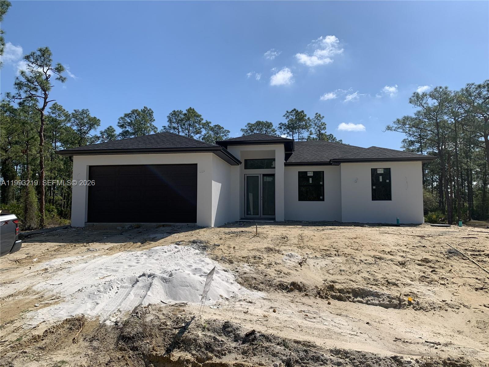 New Construction Home on Half Acre. This stunning new construction home is situated on a spacious half-acre lot in the heart of Lehigh Acres. Featuring 3 bedrooms, 2 bathrooms, and a double-car garage. This property offers the perfect blend of modern design and functional living. Step into a large, contemporary kitchen outfitted with sleek quartz countertops, stainless steel appliances, and ample cabinetry—ideal for both everyday living and entertaining. With quality craftsmanship throughout, this home delivers comfort, space, and style on a generously sized lot with room for future additions like a pool or guest house. Perfect for homeowners or investors looking for a high-quality build in a rapidly growing area!