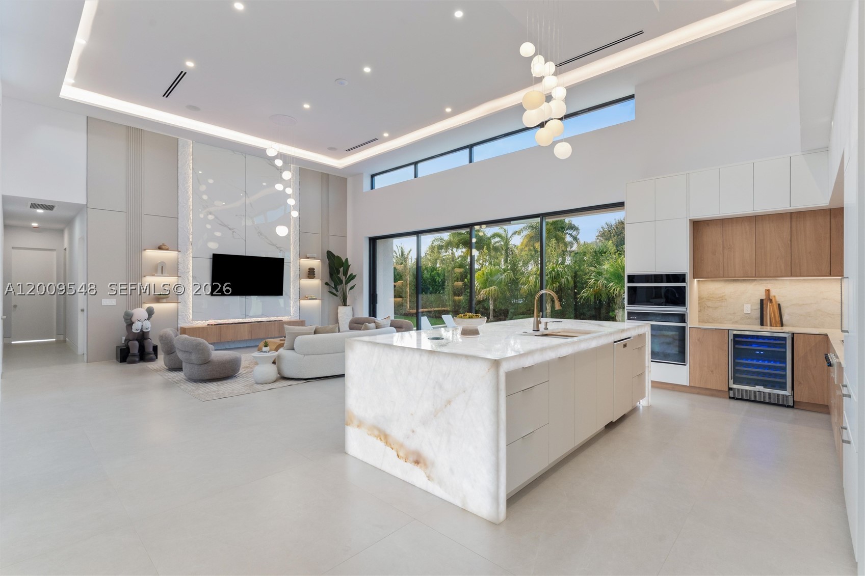 A rare opportunity to own a newly built 2026 residence with standout design and exceptional features, just minutes from Wilton Drive, Fort Lauderdale beaches, and Las Olas. This architecturally striking 4-bedroom, 4.5-bath home sits on a 10,000 sq. ft. lot in a prime section of Wilton Manors. Designed to impress, the home blends bold, loft-like scale with seamless indoor-outdoor living, highlighted by dramatic 15-foot ceilings and walls of glass. The process went well beyond drywall and paint, and every corner of this home has been carefully curated for those who appreciate the finer details. From a showcase kitchen crafted with Cristallo slabs and a Wolf gas cooktop to a dramatic floating stair and waterfall entry, the home features smart home control with audio and video, seamlessly opening to a private, resort-style backyard with heated saltwater pool, spa, and lush outdoor living, along with two primary bedroom suites—one featuring a tropical outdoor shower. This is more than a residence—it is a fully realized living environment designed to be experienced, an opportunity to own a true statement home built for both everyday living and unforgettable moments. Key features include smart switchable privacy film for garage/living room glass, EV chargers, dual-zone HVAC, smart pool controls, gas cooking, and stunning hardscape and outdoor design.