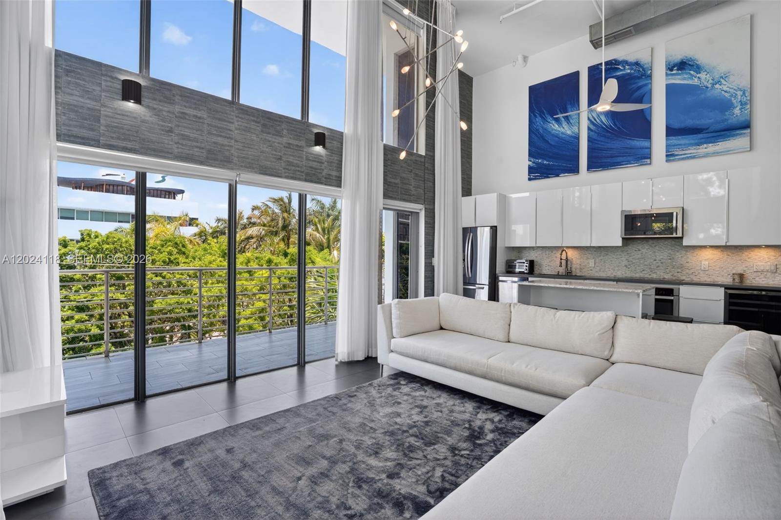 Located in the heart of South of Fifth, this rarely available corner loft is situated in the exclusive boutique building The Manhattan Lofts, where units seldom come to market. The spacious two-level residence features 20-foot double-height ceilings, floor-to-ceiling impact glass, and abundant natural light throughout. Open living and dining areas are complemented by updated kitchen and baths, custom walk-in closet, washer/dryer, and flexible space ideal for a guest room, office, or den. Enjoy a private rooftop terrace with open skyline views, balcony access, and covered gated parking. Boutique amenities include a swimming pool, secured entry, and private elevator access. Just a short distance from the beach, South Pointe Park, top restaurants, cafés, and shops.