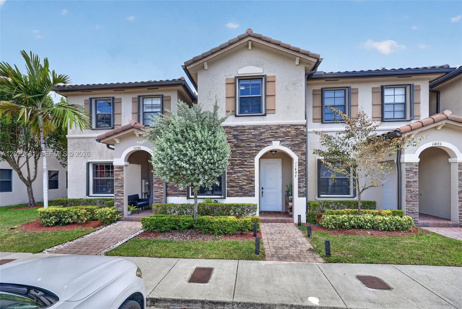 Beautifully maintained 3-bedroom, 2.5-bath townhome located in the highly desirable Artesa at Coconut Palm Estates community. This spacious residence features an open-concept layout with abundant natural light, neutral finishes, tile flooring throughout the main living areas, and a modern kitchen with stainless steel appliances, dark wood cabinetry, expansive countertop space, and oversized breakfast bar seating perfect for entertaining. The first floor offers seamless living and dining spaces with a convenient half bath, while upstairs features generously sized bedrooms including a spacious primary suite with private bath and ample closet space. Enjoy your own private fenced patio with brick pavers, ideal for outdoor dining, entertaining, relaxing, or creating your own backyard retreat. Beautifully maintained community with resort-style amenities including clubhouse, pool, fitness center, playground, and scenic walking areas. Conveniently located near shopping, dining, schools, & major highways. Ok to lease. Low HOA.