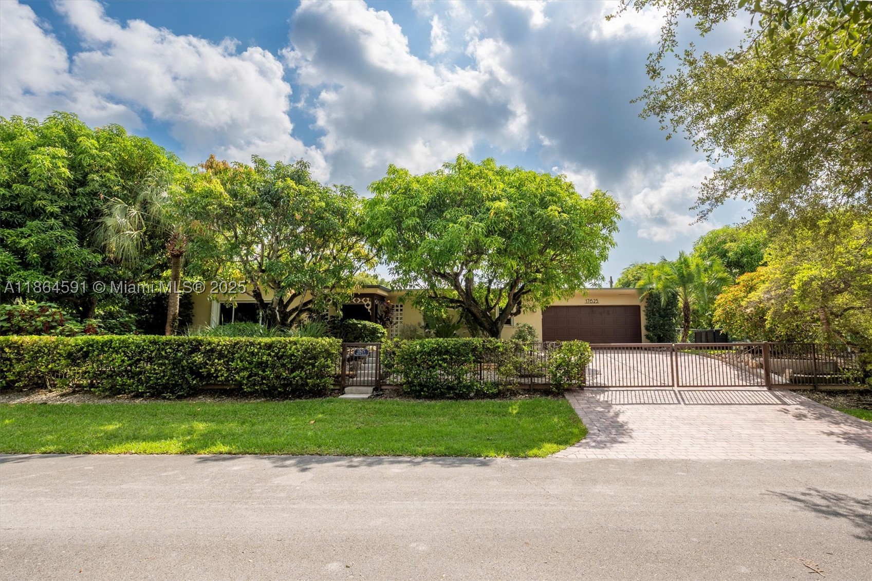 Back to Market Opportunity !!  Tropical Garden Paradise Over 1/2 Acre (25,200. sqft), perfect for Boats & RV's.  No HOA, Low Taxes, No Flood Zone (13' elevation).  Unique entrance with wood carved double doors.  Beautiful 1-story house, 3 bedr., 2 bath, plus independent 1/1 Guest House (Built 1986) as great rental income, office, gym, or In-Law Quarters.  Main House 3rd bedr. converted into open layout office but easy to convert it back.  Gorgeous kitchen w/cathedral ceiling, quartz counter tops, SS appliances.  Has a 2 Car garage with window. *2019: New PVC Plumbing Pipes and Metal Roof in Main House w/Solar Panels (owned/not leased - bill ranges $46-$123) and Flat Roof Guest House*.  Private indoor Courtyard with 6' Saltwater Heated & Screened Pool, quartz counter top extending from kitchen to pool area for entertaining & family time.  With auto sprinkler well irrigation, double storm protection in main house with impact glass windows & accordion storm shutters.  Also Accordion storm shutters in guest house, garage, and laundry.  2-A/C's: Main house(2022)/Guest House(2025).  True Gardeners dream with trees like Mangos, Mulberry, Avocado, Lychee, Longan, Soursop, etc.. with beautiful limestones around backyard.  Potential to build another home in the other side corner.  Owned security video cameras system inside & outside ring included.  Great Schools, 10 min. from Palmetto Bay Golf Course & 4 min. from Palmetto Bay Park.  A Forever Home with Endless Future Potential !!