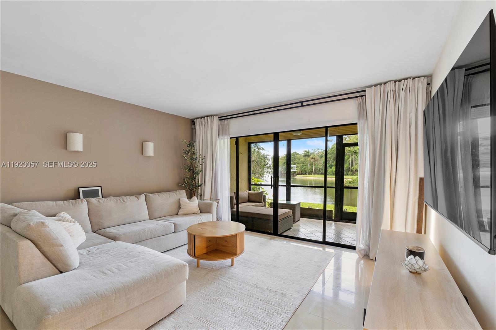 Enjoy extra space and peaceful lakefront living in this oversized 1BD/2BA first-floor condo at Hammocks Lake Forest. With 1,156 SF, this home features tile flooring throughout and an updated kitchen with stainless steel appliances and a center island. The spacious bedroom includes a walk-in closet and a private bath with a tub and double vanity. A second full bathroom with a walk-in shower adds convenience for guests. Relax on your private balcony with serene water views and direct lake access. The unit includes a full-size washer/dryer, one assigned parking space, plus additional unassigned resident parking and ample guest parking. Community amenities include a pool, tennis and basketball courts.