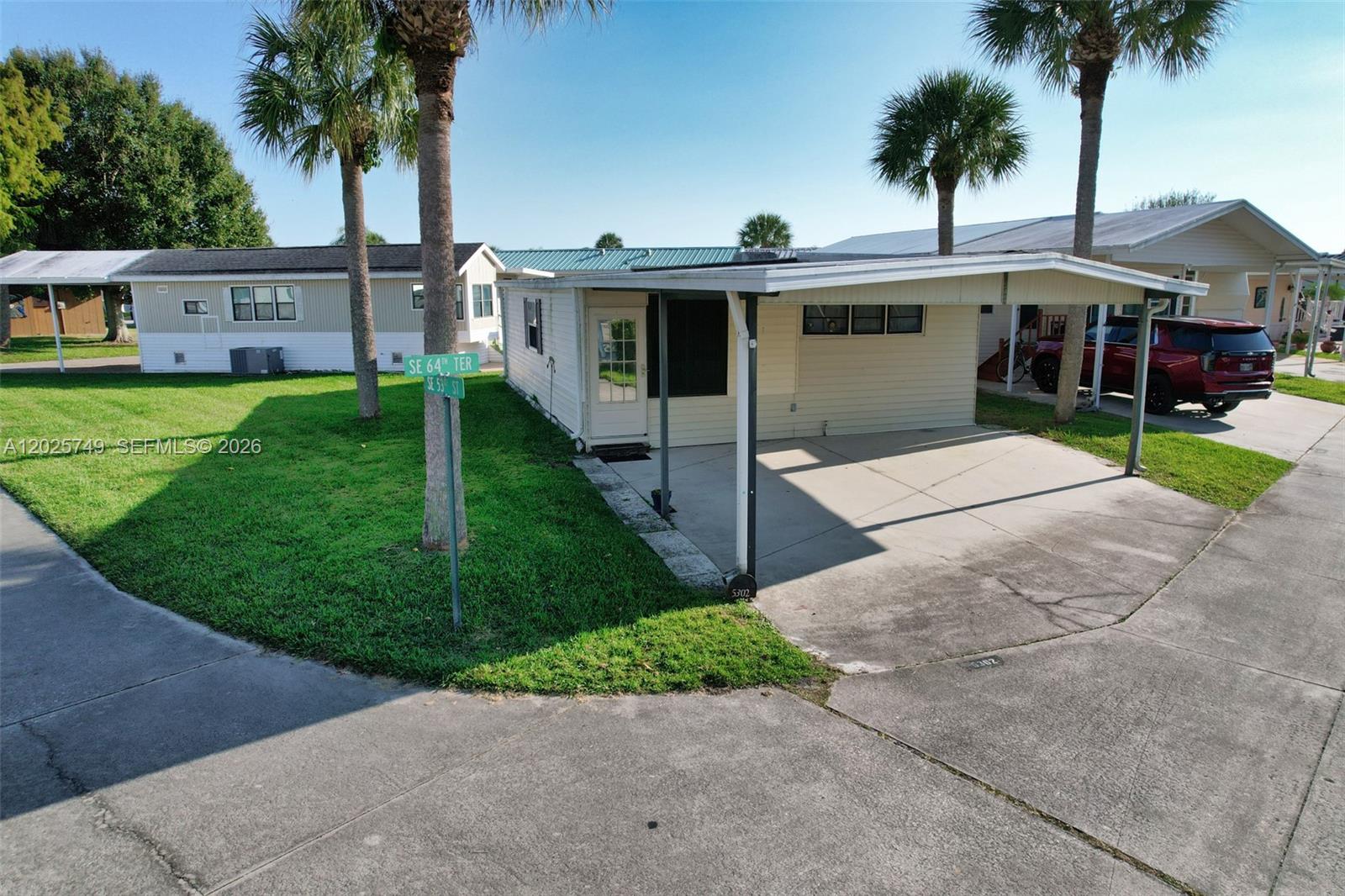 PRIME CORNER LOT in desirable Ancient Oaks RV Resort with Lake Okeechobee Access, boat ramp, docks, fish cleaning station, clubhouse, pool, game room, and more. This 1 bed /1 bath features central A/C, upstairs kitchen, enclosed Florida room with solid flooring, 2-car attached carport, enclosed laundry room, extra storage room, wide road access, and a large lot. Excellent opportunity in one of the community’s best locations! 55+ community.