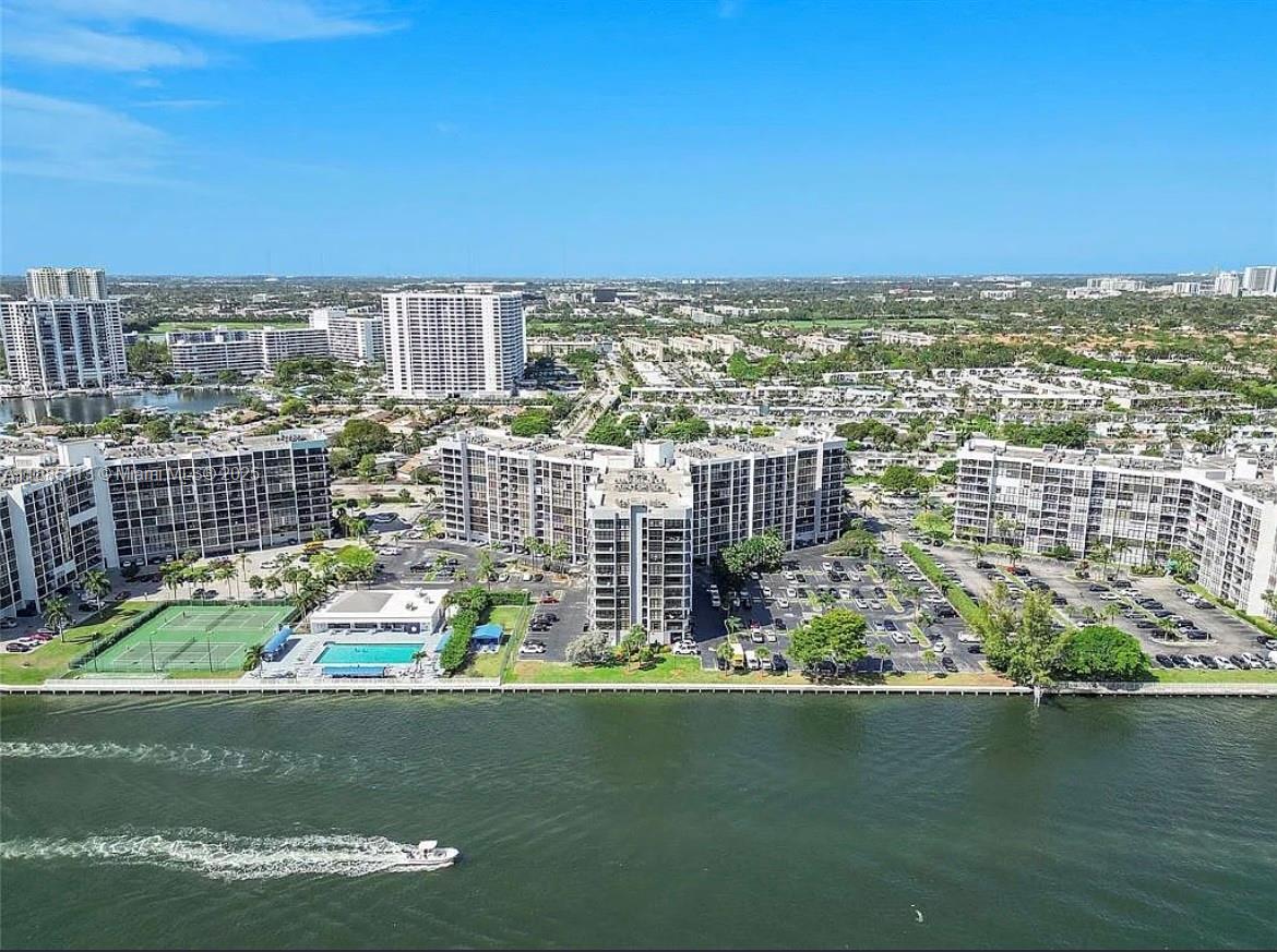 Bright and spacious 2 bedroom, 2 bath furnished apartment, freshly painted with porcelain flooring and washer/dryer in unit. Condo has a large, primary bedroom with a huge, walk in closet. Includes basic cable, wifi, water, covered parking, guest parking, exterminator and 24 hour security. Experience resort style amenities including a heated waterfront pool, sauna, tennis, gym, exercise room, clubhouse and social room. Minutes to the beach, shopping, dining and parks. Ideally located in Three Islands neighborhood, this beautiful Intra-coastal community, offers stunning city and water views from the open balcony. Call listing agent to schedule a tour today.