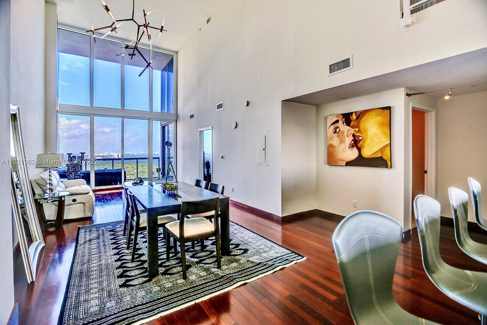 VERY RARE OVERSIZED 2 FLOOR PENTHOUSE WITH 20 FEET FLOOR TO CEILING WINDOWS IN THE MOST DESIRABLE NEIGHBORHOOD OF MIAMI. Ceilings soaring an unbelievable height above 20 feet with floor-to-ceiling windows and a modern Italian chef’s open kitchen with amazing views of Downtown Miami and Biscayne Bay. Electric blinds in master bedroom. Enjoy the great and renovated amenities Blue Condo has to offer. Located in Edgewater, the penthouse is walking distance to the famous Miami Design District, Midtown, Wynwood, and minutes ride to Miami Beach or Brickell. This unique penthouse comes with 3 parking spaces + storage.