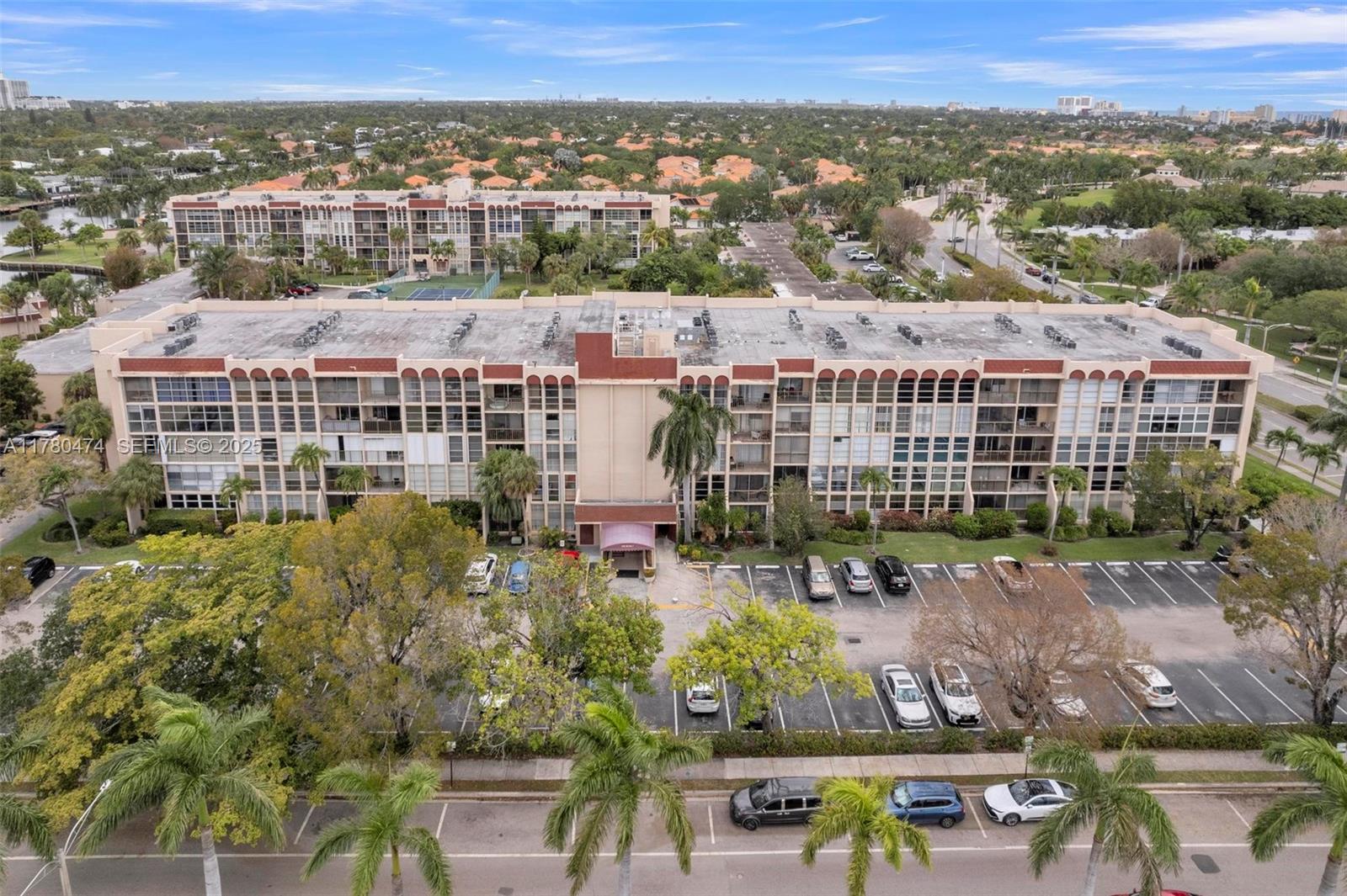 This corner unit features two bedrooms, one full bathroom, and a half bathroom, spanning 1,200 square feet of living space. The floor-to-ceiling windows provide ample natural light, while the tile floors and screened-in balcony add to the modern aesthetic. Cable TV and internet are included in the maintenance fee. Residents can enjoy the heated pool, tennis courts, sauna, and clubhouse/social room. Conveniently located near Joseph Scavo Park, shopping, and Hallandale Beach, this property offers a perfect blend of comfort and convenience.***SPECIAL ASSESSMENT PAID IN FULL & WIFI AND CABLE TV INCLUDED IN MONTHLY MAINTENANCE FEE***