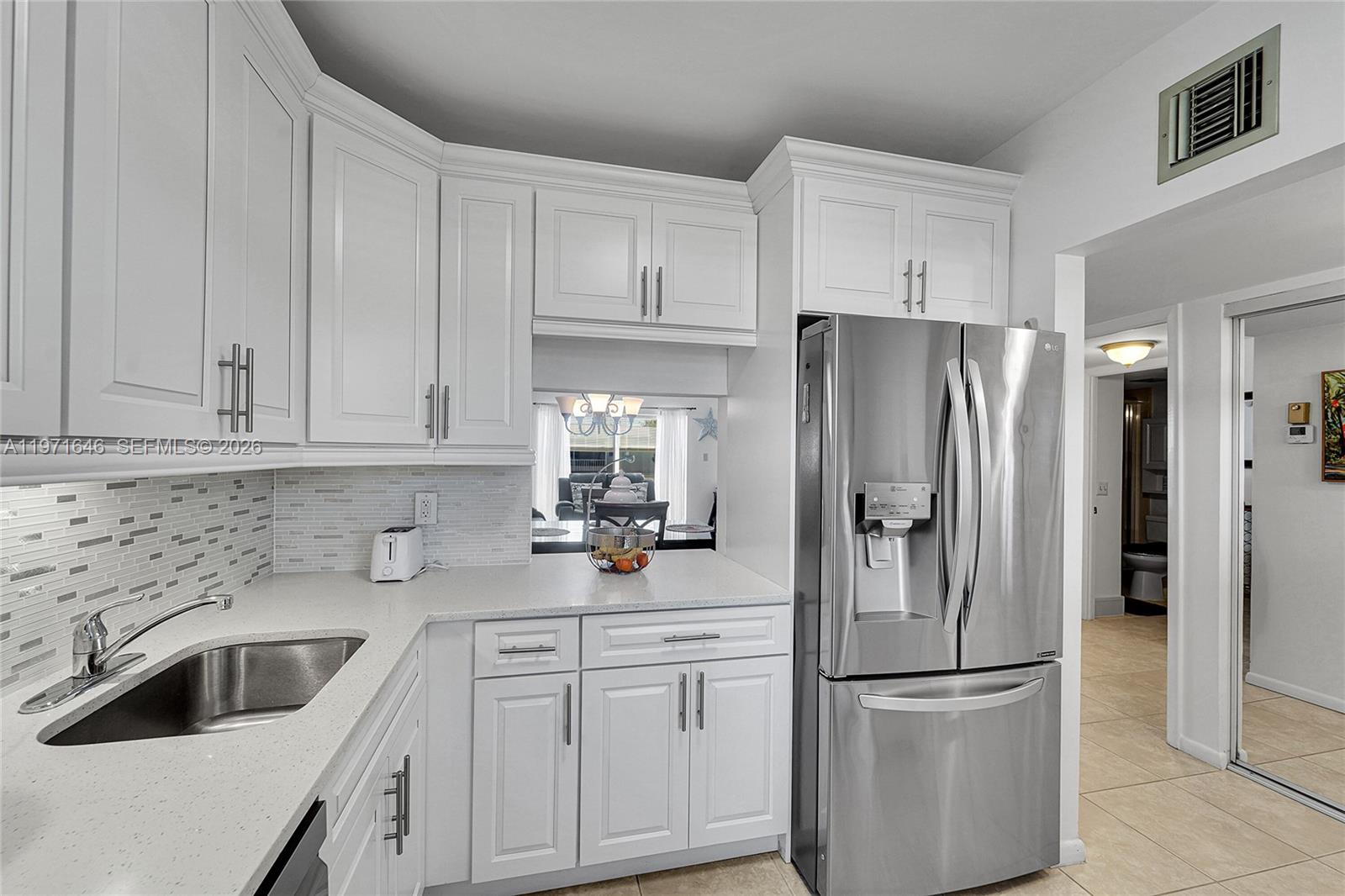 Just Gorgeous! Stunning & Spotless 2-bedroom, 2-bath condo in desirable Oriole Gardens Two, a well-maintained 55+ community. Offering over $60,000 in upgrades, this beautifully updated unit features a remodeled kitchen with stainless steel appliances, updated bathrooms by Bath Fitter, recently painted interior, and tile flooring throughout. A/C replaced April 2025. Hurricane impact windows and sliding door provide added protection and peace of mind. Walk in closet.  Clean, bright, and completely move-in ready. New roofs are currently being installed. Enjoy resort-style amenities including an active clubhouse with social activities, fitness options, and a beautiful community pool. Ideally located within walking distance to shopping, banks, restaurants, and everyday conveniences. Don't miss this beauty!