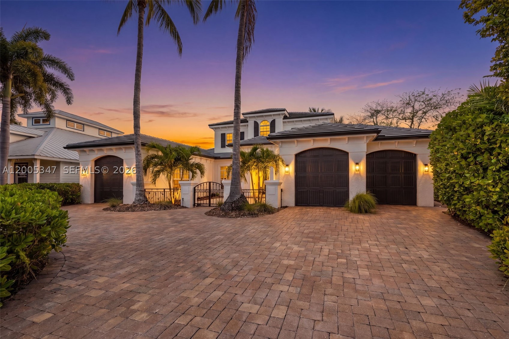 Welcome to luxury waterfront living in the highly desired McGregor Isles, one of Fort Myers’ premier boating communities with direct Gulf access. Set on a quiet cul-de-sac, this custom home offers breathtaking intersecting canal views, SW rear exposure, and stunning sunsets, complemented by seamless indoor-outdoor living. A lush tropical entry leads to a light-filled open floor plan with coffered ceilings, designer finishes, and panoramic water views throughout. The remodeled chef’s kitchen features quartz countertops, an oversized island, Wolf ovens & gas cooktop, and Miele dishwasher & a climate-controlled wine cellar. Expansive sliding glass doors open to a resort-style outdoor space with a panoramic screen, pool, fireplace, and generous entertaining areas. The first-floor primary suite offers serene water views, dual walk-in closets, and a spa-inspired bath, while the main level also includes formal living & dining areas, a home office, half bath, and laundry room. Upstairs features a flexible loft-style living area with screened balcony and three bedrooms, including a private en-suite and Jack-and-Jill layout. Upgrades include white oak flooring, impact windows and doors, a whole-home generator, and a 2025 roof on home & boathouse, 2026 hot water heater. An extended dock and covered boathouse accommodate up to a 36-foot boat with no bridges and quick Gulf access—just minutes from beaches, shopping, and dining, offering the ideal blend of luxury, location, and lifestyle.