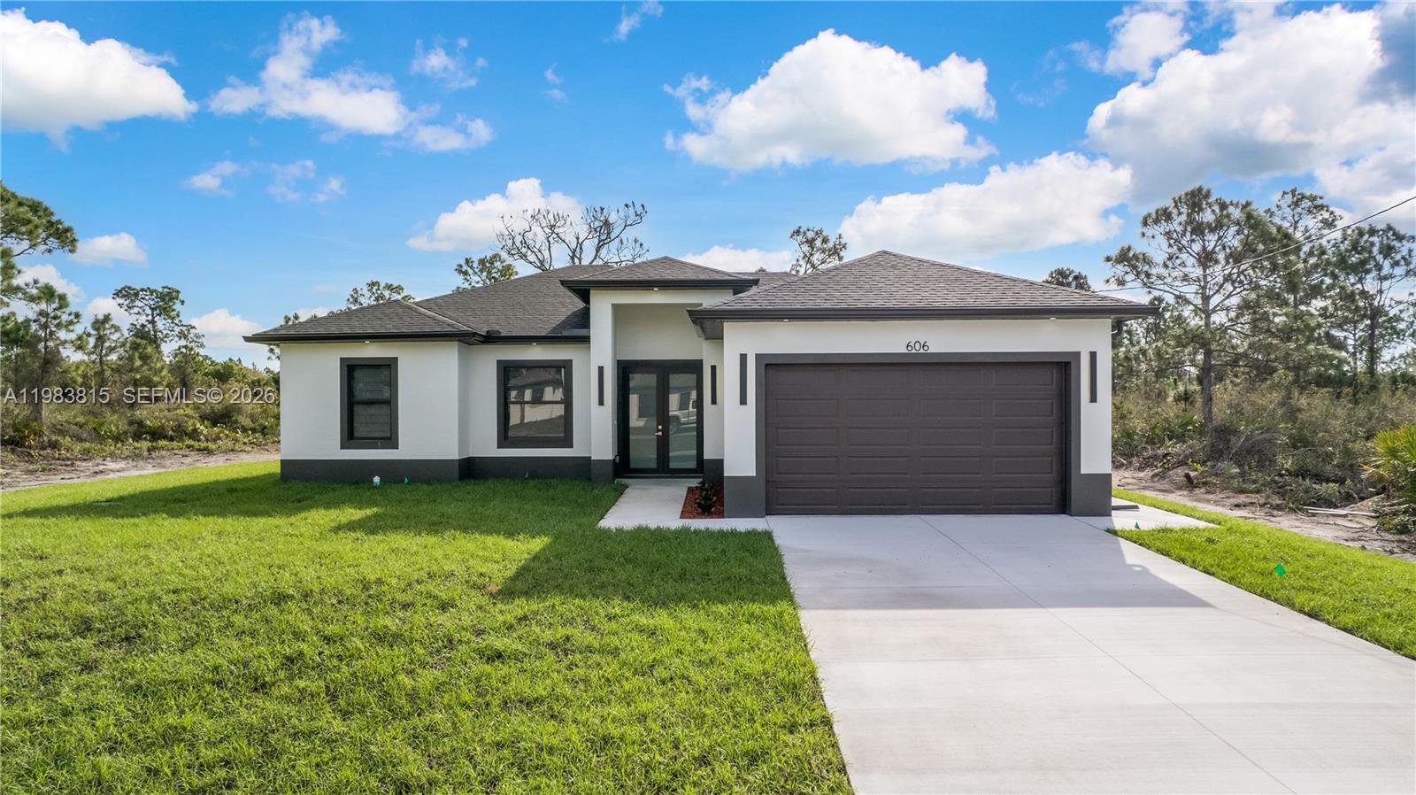 Move-in ready New construction home in fast-growing Lehigh Acres, Lee County! This 4 bedroom + 2 bath residence offers modern open concept living, high ceilings, impact-resistant windows & doors, and energy-efficient design, all built with craftsman-level finishes for quality and durability. The kitchen features custom tile backsplash, sleek countertops, and stainless steel appliances, perfect for cooking and entertaining. Enjoy a beautifully maintained lush green lawn with sprinkler system, plenty of yard space, and a generous driveway with extra parking for vehicles or RVs.

Located in a community with abundant outdoor recreation, parks, walking & biking trails, you’re minutes from Veterans Park & Recreation Center, playgrounds, athletic fields, and scenic greenways. Golf lovers are close to Majestic and Westminster clubs, and nature enthusiasts will enjoy Harns Marsh and Hickey’s Creek preserves. Daily conveniences, local dining, cafés, and shopping are nearby on Lee Blvd and Homestead Rd.

Lehigh Acres offers quick access to Fort Myers, the Caloosahatchee River, and Gulf Coast beaches including Fort Myers Beach, Sanibel & Captiva. This home delivers quality construction, modern design, and a prime location in Lee County, perfect for anyone searching for move-in ready, energy-efficient, new construction homes with impact windows.