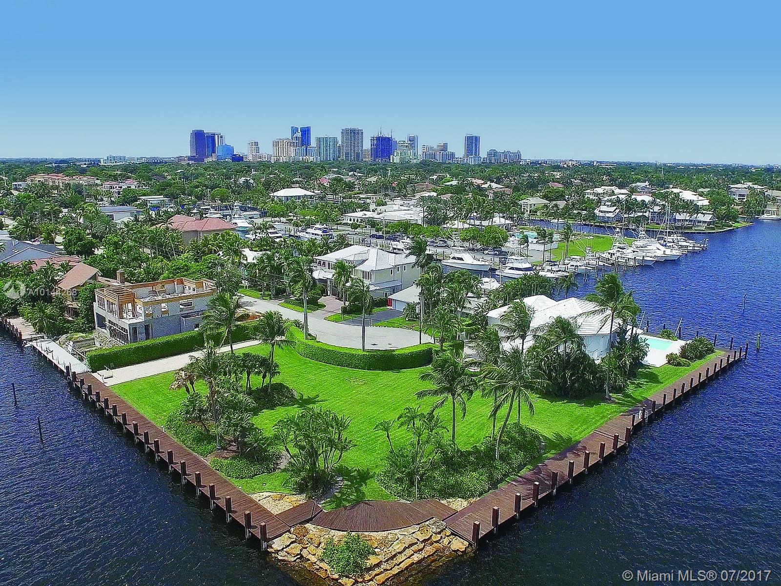 Rare and spectacular SE Intracoastal point double lot in desirable Lauderdale Harbors. 335' of waterfront with unparalleled views of the Intracoastal.  Dock your mega-yacht on the side and still enjoy a direct Intracoastal view.  Lushly landscaped property with mature palm trees is ready for a custom estate home which would offer one of the finest wide water views in all of South Florida.  Just 10 minutes to the ocean by boat or yacht.  Truly a one of a kind offering.