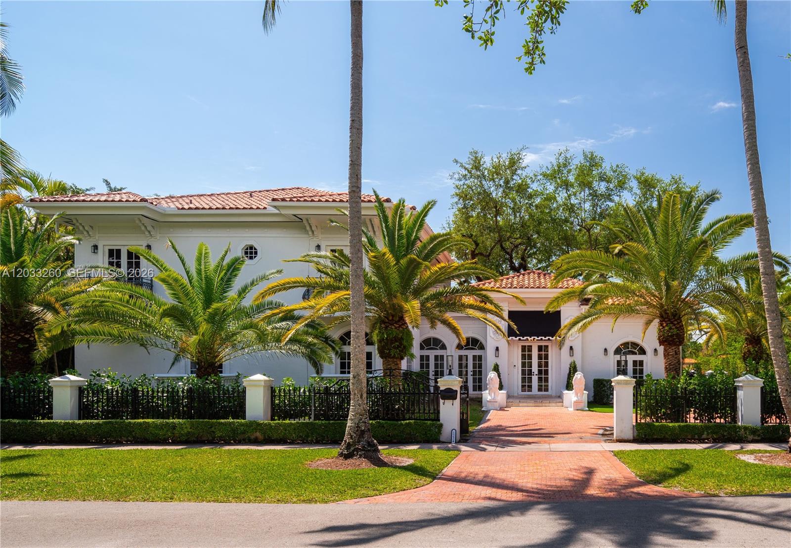 Built in 2003 this Mediterranean style 2 story home is incredibly spacious, light and bright with an A+ address just steps to the Biltmore Hotel, Salvadore Park and the Venetian Pool. This close to 5000 square foot home has 14' tall ceilings and tall Palladian windows that bring in the light and create a sense of wide-open airiness throughout. All major rooms open with French doors to a charming, spacious courtyard presided over by a magnificent, ancient oak tree at its center.  The 13,875 square foot lot is walled and gated. The 2nd floor primary bedroom suite measures 24'X20' and has 2 huge walk-in closets. There are 3 other bedrooms upstairs and 1 bedroom down plus a maid's bedroom & bath plus 2 offices. Foyer, formal living rm, family room, formal dining room, pool, 2 car garage. Floor plan available.