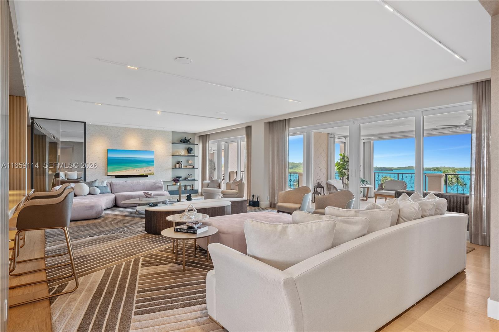 THE EPITOME OF LUXE LIVING WITH BREATHTAKING MIAMI SKYLINE & OPEN BAY VIEWS THIS FISHER ISLAND RESIDENCE IS CURATED BY RENOWNED DESIGNER CARLA CANEPA! Turn-Key Home where every detail has been Crafted to Perfection w/Sierra Italian furnishings. Spacious 5-Bedrooms + Office, 5.5-Bath offers 6,120 SF of refined interior living space. Expansive terraces w/Sunset Views. Listone Giordano Italian Light Oak Wood Floors, Chef's Kitchen w/Double Premium Wolf Appliances. Bar area w/Polished Onyx Bar & Temp Controlled Wine Room. Powder Room in Blush Onyx. Expansive Primary Bedroom Suite w/separate Walk-In Closets & Primary Bath wrapped in Exotic Book-matched Slab Stone + Soaking Tub w/Matte Gold Dornbracht fixtures. Impact Glass Doors & Lutron & Sonos. AC Storage. 2 Parking Spaces + XLGolf Cart Space