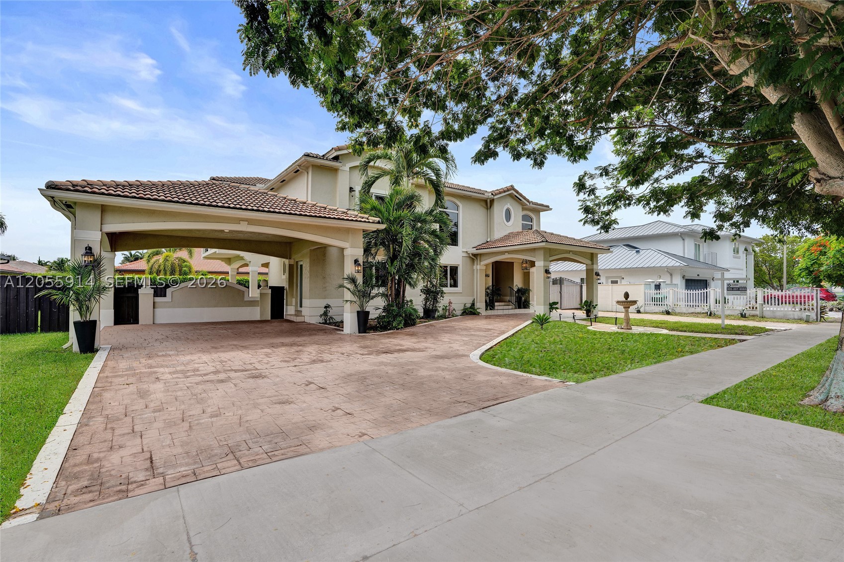 Welcome to this custom-built Mediterranean masterpiece of unrivaled distinction in Barima Estates, meticulously crafted by an owner-contractor with uncompromising quality. Boasting architectural grandeur on an oversized, fully gated 10,000+ sq. ft. lot, this estate features a striking circular driveway with a grand porte-cochère, a dramatic foyer, and a custom ironwork master staircase. Built to last with a solid concrete second-floor slab, a durable tiled roof, and a private residential elevator, the spacious layout offers tiled floors throughout, a formal dining room, an expansive family room, and a convenient first-floor bedroom suite. The heart of the home is a newly remodeled chef’s kitchen that opens effortlessly into a sunlit Florida room, creating an exceptional venue for indoor-outdoor entertainment with ample space for a future pool or luxury RV. Enjoy complete freedom with zero HOA restrictions in a home that truly stands out from the rest. Don't miss this rare opportunity—schedule your private tour today before it's gone!