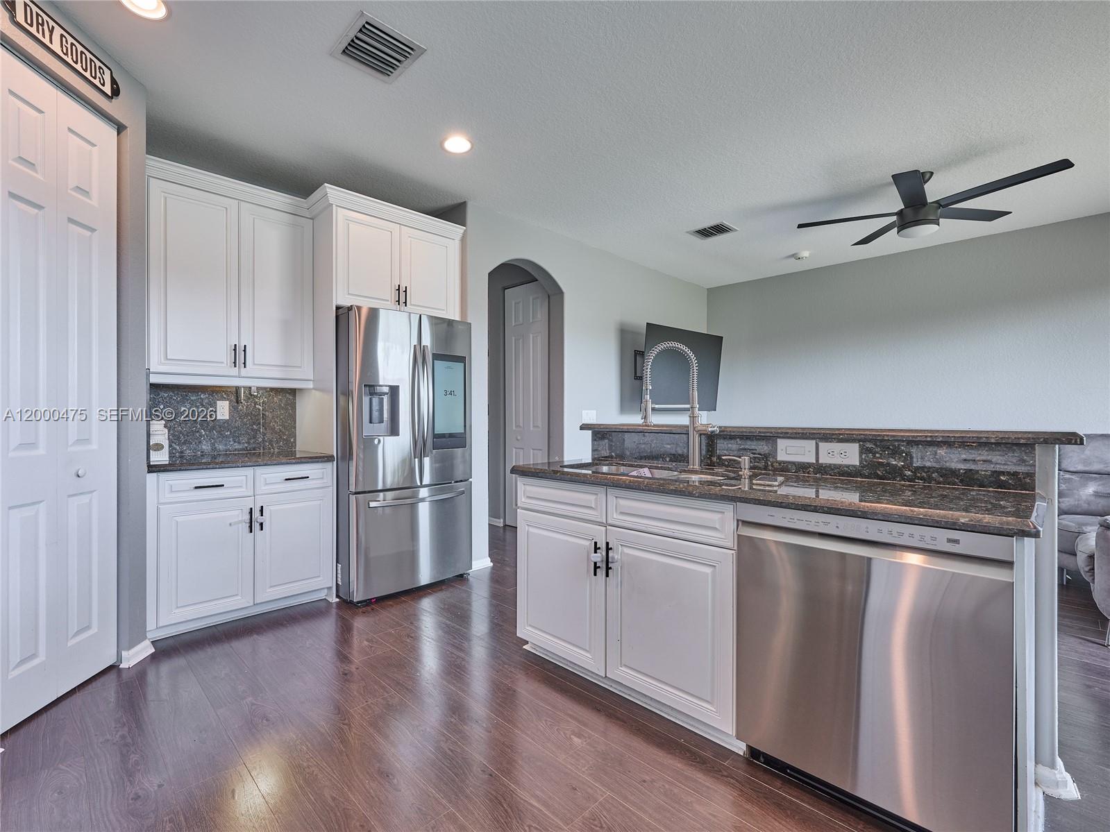 Spacious and move-in ready, this 4-bedroom, 3.5-bath townhouse offers stylish vinyl wood-look flooring throughout with no carpet and a newer A/C for added comfort and value. The open-concept kitchen features granite countertops and stainless-steel appliances, seamlessly flowing into a bright dining area with access to a private patio overlooking a peaceful lake. Located in a highly desirable, centrally situated community with resort-style amenities, including a heated pool, tennis and basketball courts, fitness center, playground, BBQ areas, and more. Zoned for A+ schools and just minutes from premier shopping, dining, and everyday conveniences. Investors welcome—rent immediately. Pet-friendly community. HOA resale capital contribution is $2,000. HOA includes roof, exterior maintenance, common areas, and full access to amenities. Ideal for homeowners and investors alike.